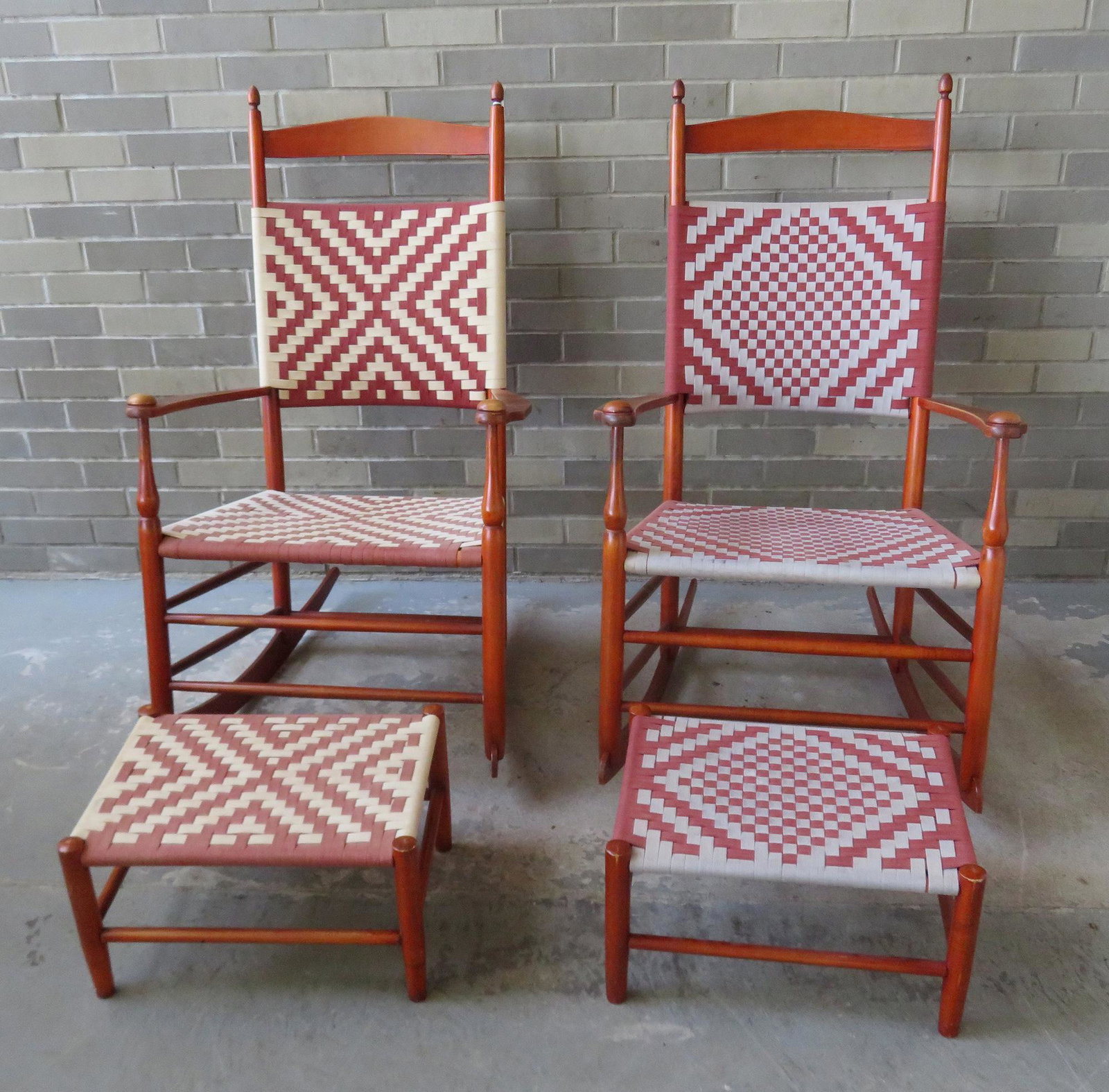 Two custom made Shaker rockers with matching footstools: Two custom made Shaker rockers with matching footstools in typical Shaker red stain. Not signed but made by the Ingersoll Cabinet Makers, Cornwall CT. All 4 pieces with woven seats and backs and are i