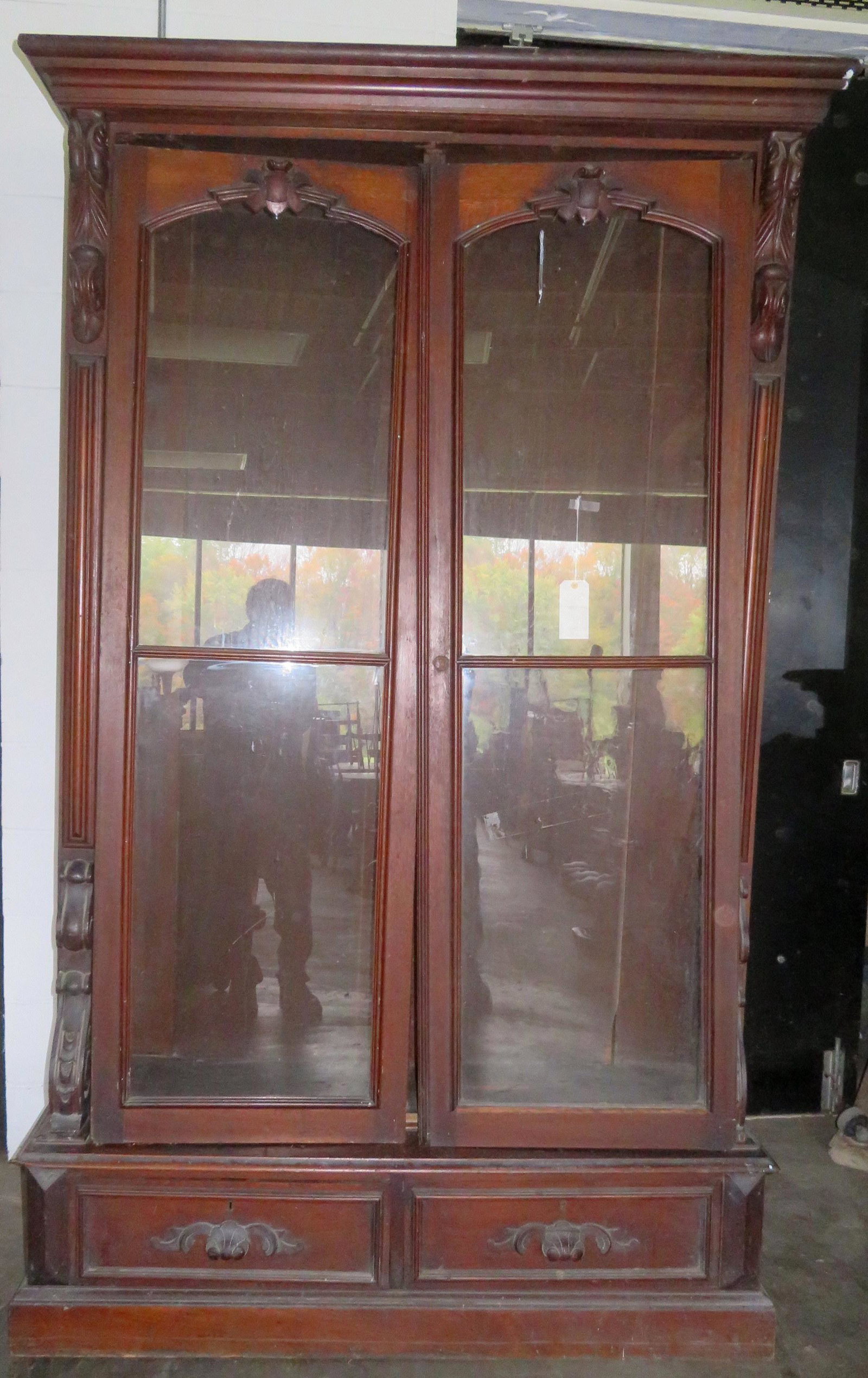 Black walnut 2 door bookcase having 2 lower drawers -: Black walnut 2 door bookcase having 2 lower drawers - doors have been removed as well as cornice and needs to be reassembled - note that the metal strips that help keep the doors to the top of the boo