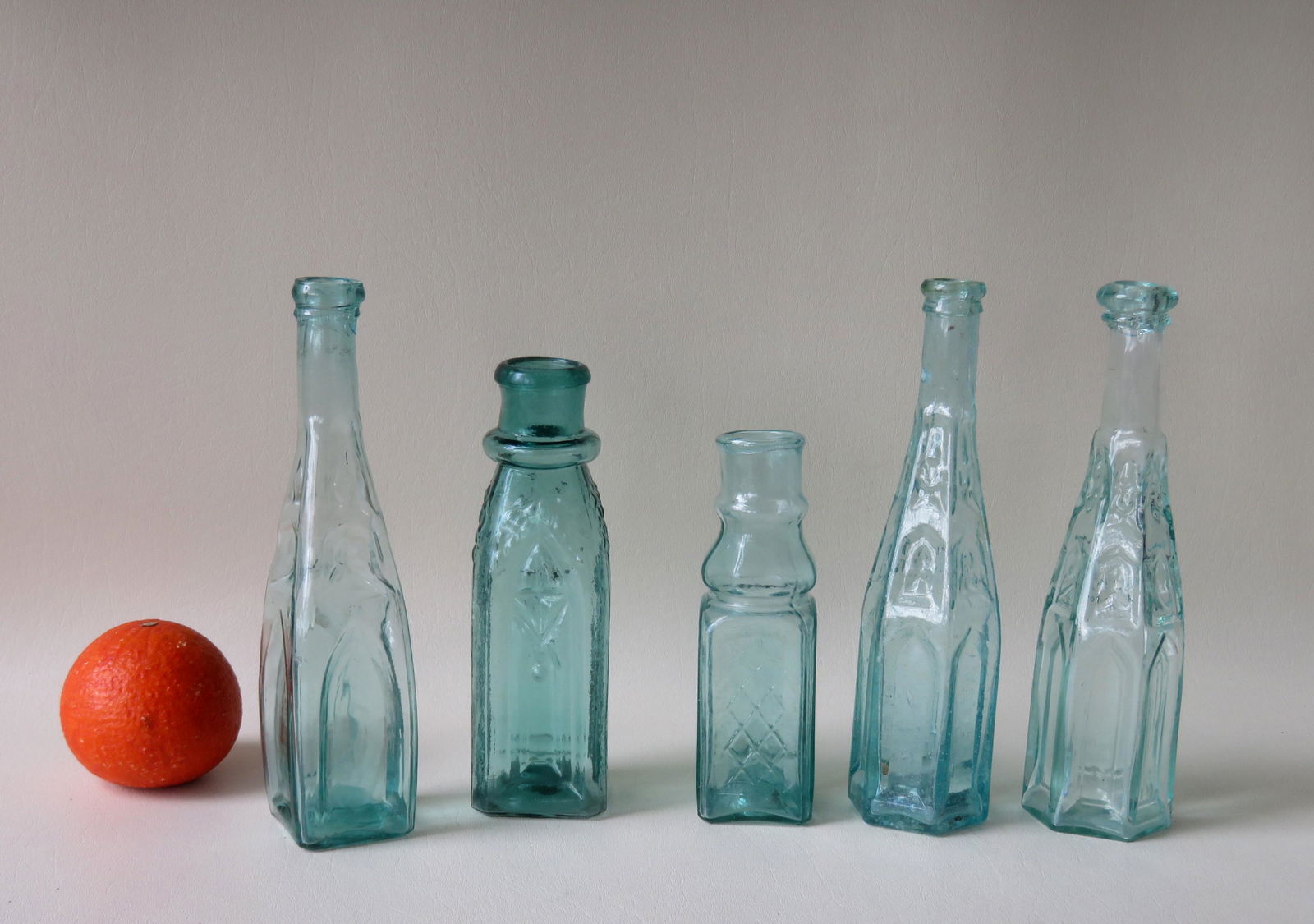 Collection of 5 vintage bottles including 3 cathedral: Collection of 5 vintage bottles including 3 cathedral aqua pepper sauce bottles and 2 small pickle jars. One light green pickle jar with rolled lip and pushed-up pontiled base - 7 1/2"H, and the other