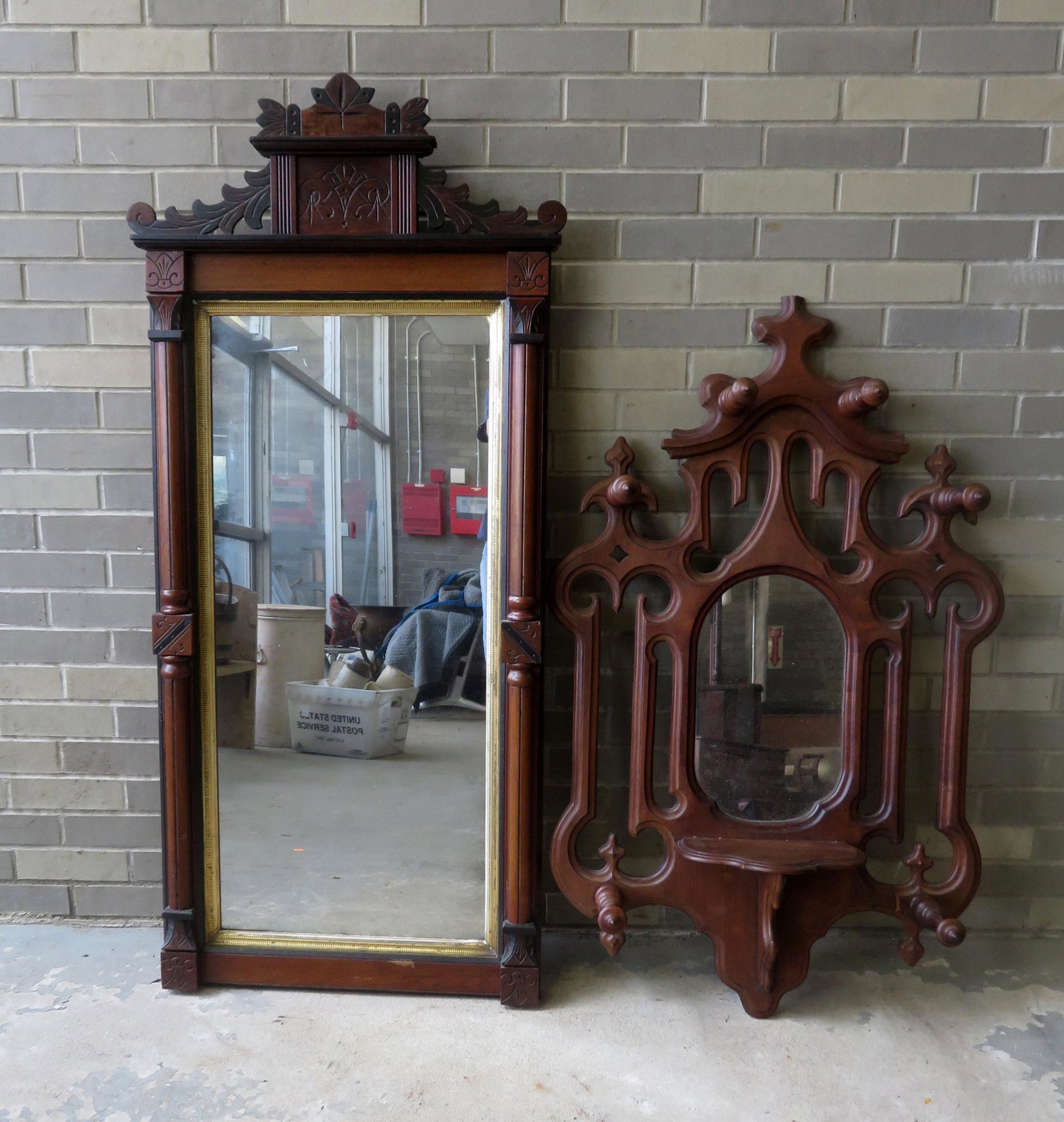 Two Victorian wall mirrors, one with hat hooks and: Two Victorian wall mirrors, one with hat hooks and slight repair to scrolled side, otherwise both in good condition, 19th century. The largest 26"W 57"H. Provenance: From the Stanley Blum estate, Rhin