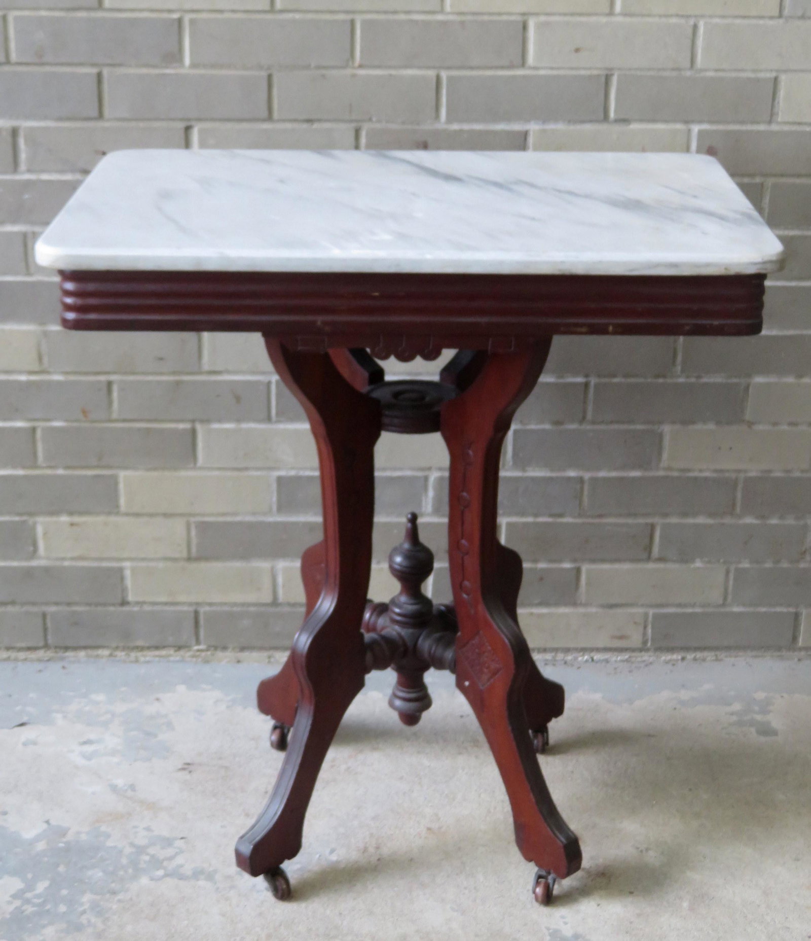 Victorian black walnut marble top lamp table, very good: Victorian black walnut marble top lamp table, very good condition with castors. 28 1/4"W x 18 3/4"D x 30 1/4"H. Provenance: From the Stanley Blum estate, Rhinebeck NY.