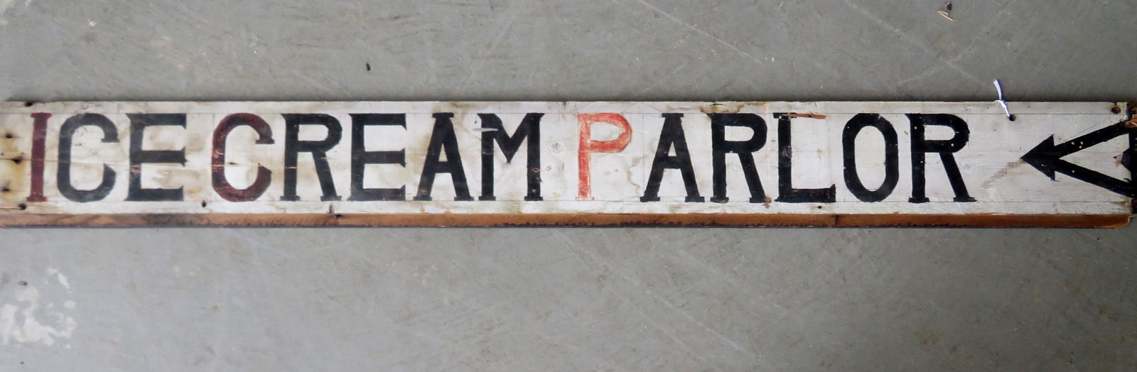 A country store sign, painted on building clapboard in: A country store sign, painted on building clapboard in old and probably original paint marked "ICE CREAM PARLOR". Wear and abrasions, overall good condition. Early to mid 20th century. 60 1/2"L x 6 3/