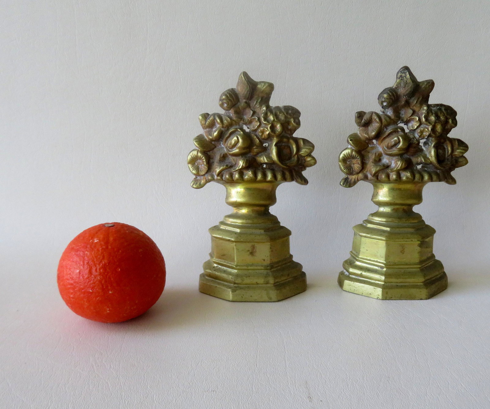 Two matching brass door stops in the form of flowers in: Two matching brass door stops in the form of flowers in urn mounted on stepped plinth, lead weighted, late 19th to early 20th century. Both in very good condition. 7"H x 3 5/8"W.