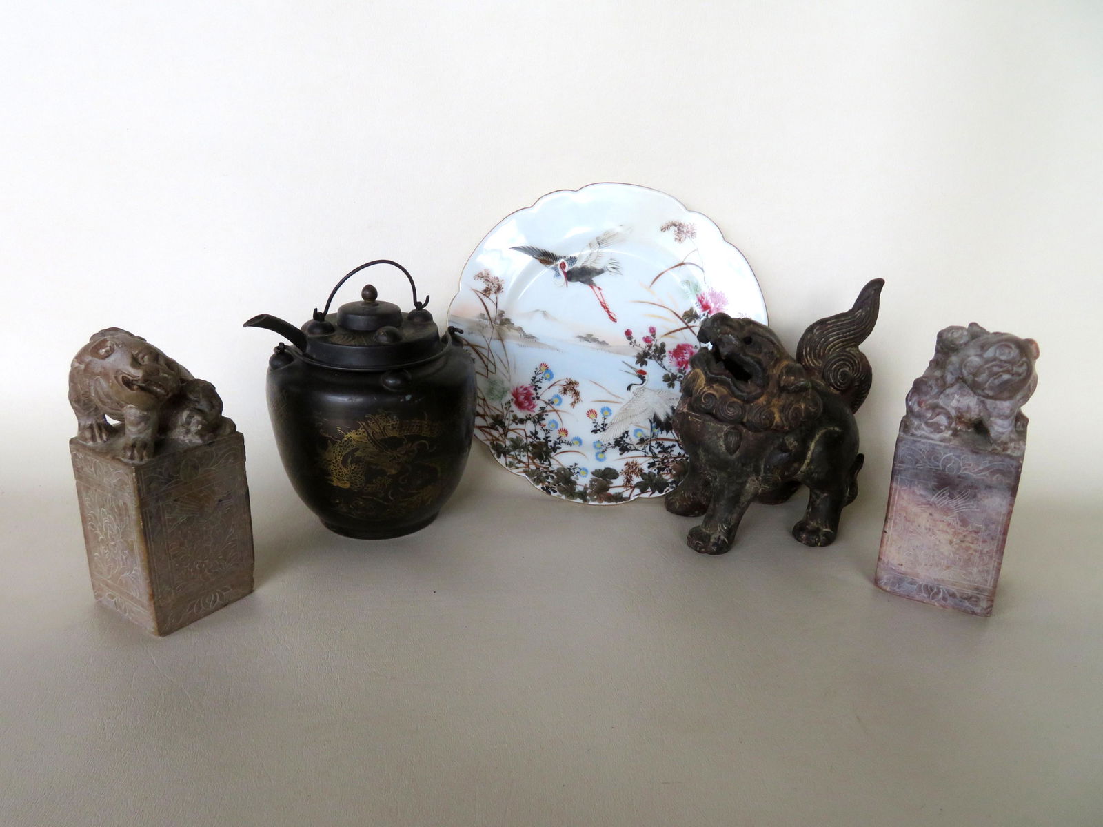 Grouping of vintage oriental decorative objects: Grouping of vintage oriental decorative objects including: A hand painted plate decorated with exotic birds and signed on verso - 19th century; pair of Chinese etched soapstone seals - minor chips on