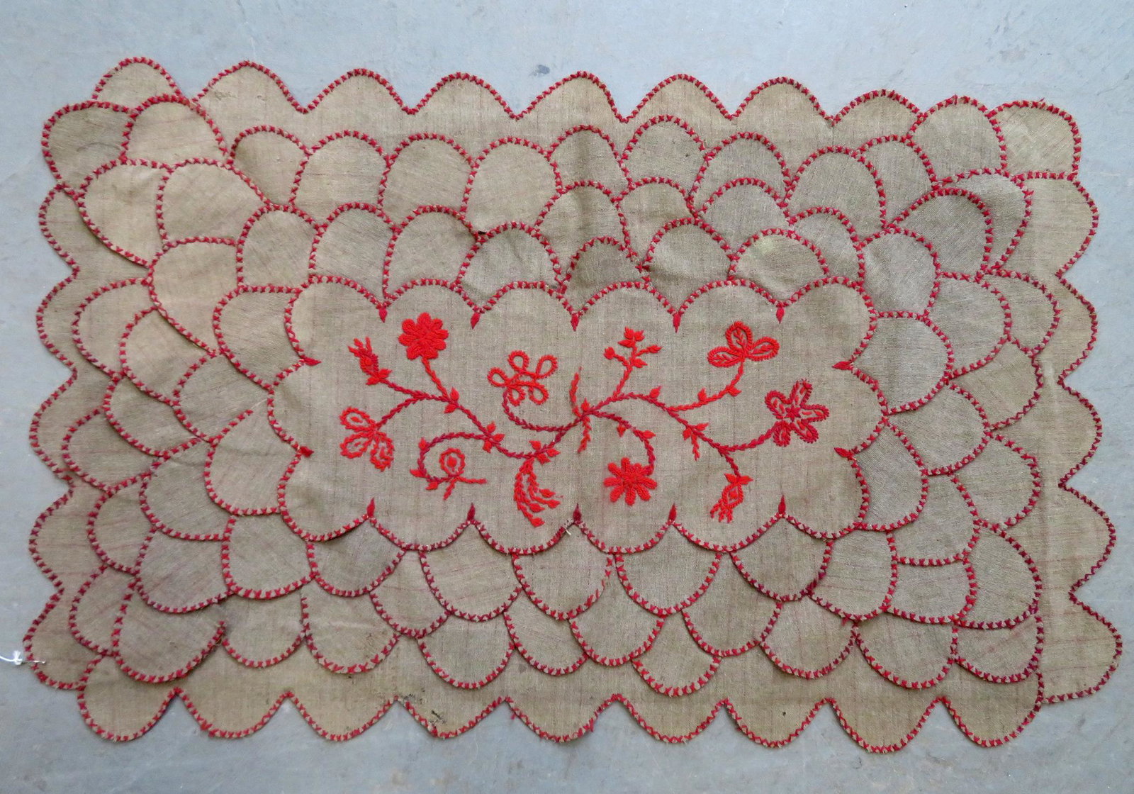 A wool table penny rug with embroidered sprig of: A wool table penny rug with embroidered sprig of flowers in the center, 19th century. 39" x 24". Minor moth damage, and overall good condition. Provenance: From a private Hudson Valley owner's lifetim