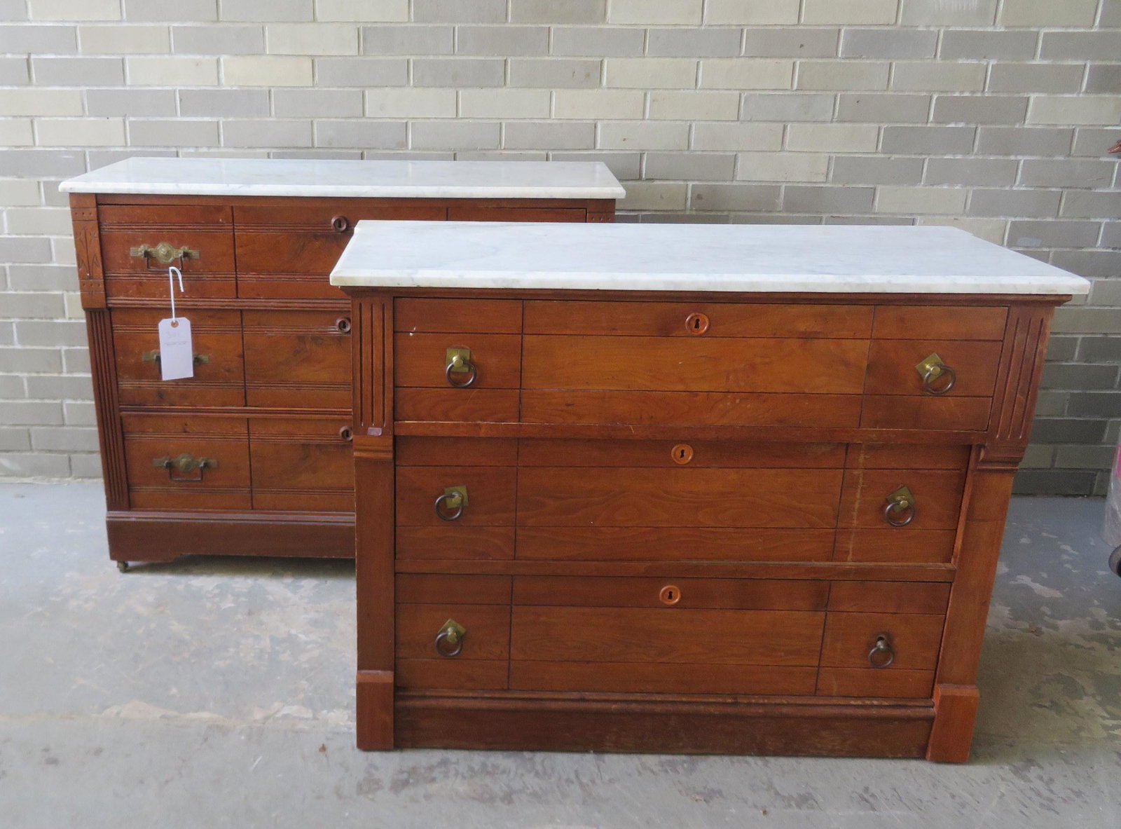 Two Victorian Eastlake walnut marble top dressers, each: Two Victorian Eastlake walnut marble top dressers, each with 3 drawers and no mirror. All with some use wear but overall good condition. Note the set of owl brass pulls on one dresser. The largest 41"