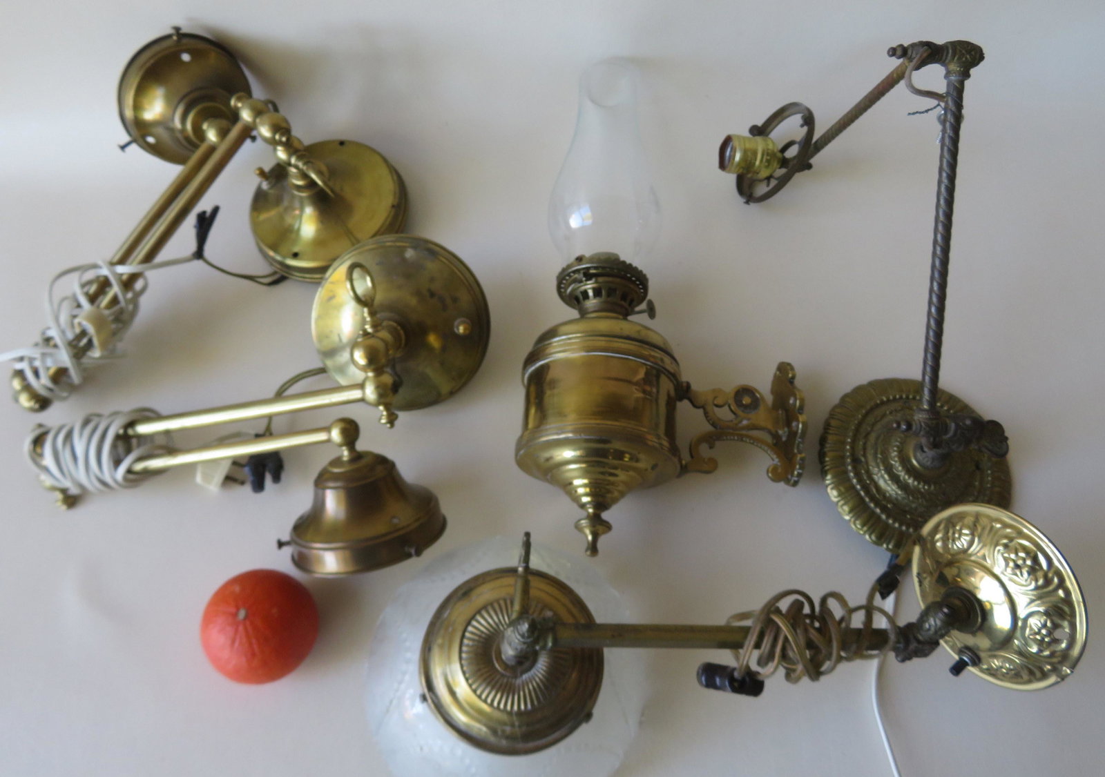 Five wall mounted Victorian brass oil lamps, most: Five wall mounted Victorian brass oil lamps, most restored, including: 1 brass oil lamp signed Miller, 1 gas fixture that have been electrified, and 3 extension lamps that have been gas fixtures but h