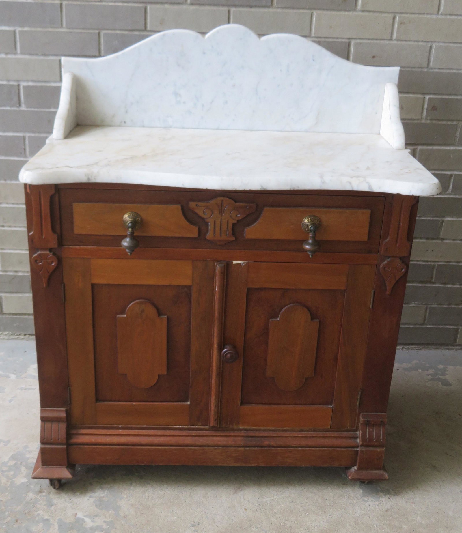 Victorian black walnut marble top washstand with: Victorian black walnut marble top washstand with backsplash, very good condition. 30"W x 18"D x 37"H. Provenance: From the Stanley Blum estate, Rhinebeck NY.
