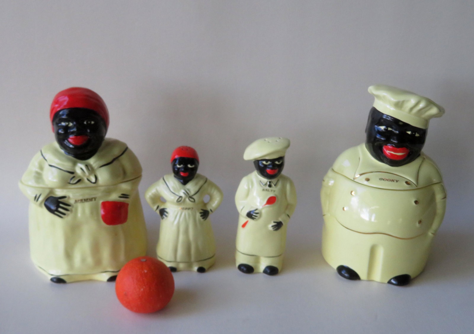 Black Americana - Two cookie jars marked "Cookie" &: Black Americana - Two cookie jars marked "Cookie" & "Mammy"" - 10 1/2"H - signed Pearl China Co. #639 on underside of base ; and a matching pair of salt & pepper shakers of "Peppy" & "Salty" - 7 1/4"H