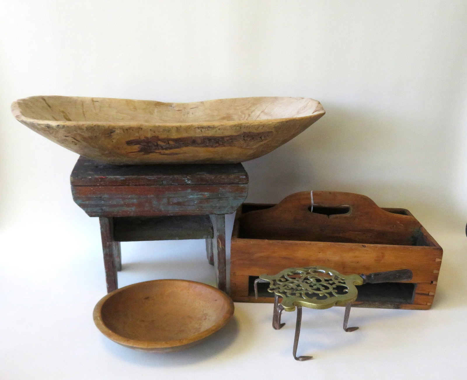 A grouping of 5 country items including a primitive: A grouping of 5 country items including a primitive cricket stool, a primitive treenware bowl - losses on 1 end, brass and iron fireplace trivet - circa 1800, a small treenware turned bowl - 19th cent