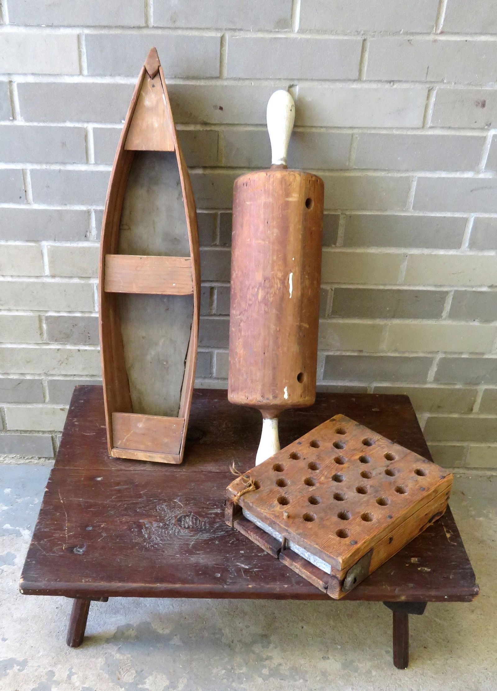 Grouping of 4 country items including: A warming stone: Grouping of 4 country items including: A warming stone in original perforated wooden frame; a rowboat model - 24 1/4"L x 6 1/4"W x 3 7/8"H; a large rolling pin (had leg supports which are missing); an