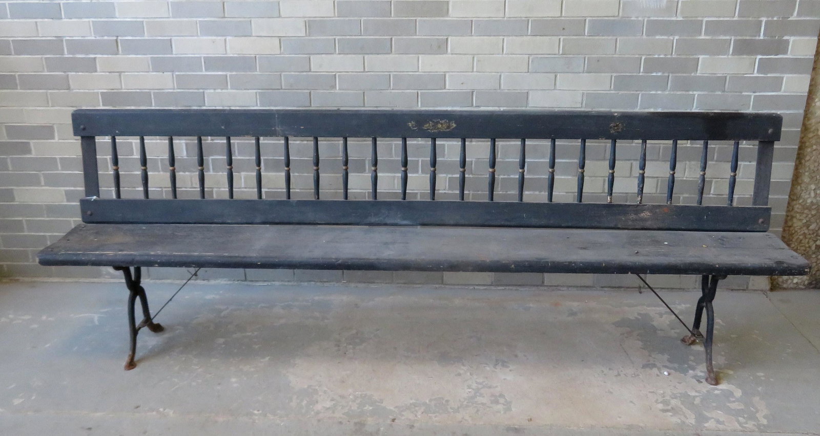 A spindle back railroad bench, late 19th century. It: A spindle back railroad bench, late 19th century. It originally had a reversible swivel back, but has been converted to a stationary bench and is in good stable condition - 96 1/2"W x 16"D x 32"H.