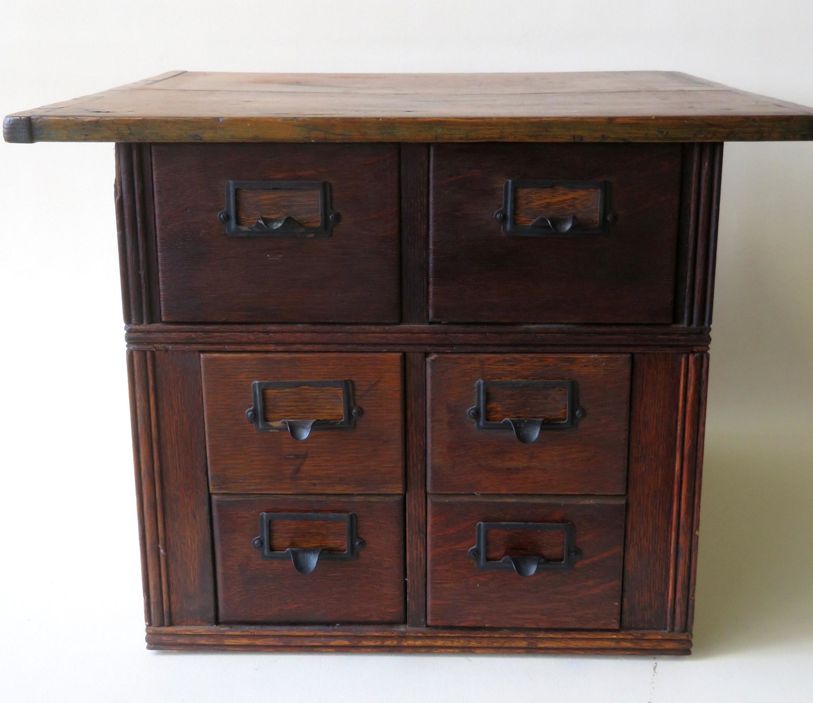 An oak 6 drawer library file cabinet, early 20th: An oak 6 drawer library file cabinet, early 20th century. The top with breadboard ends likely a replacement (from the 19th century) - 22"W x 18 1/2"D x 16 1/4"H. Good condition.