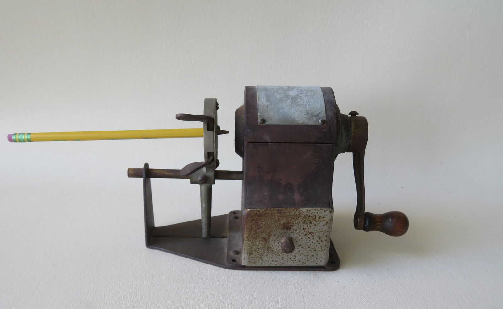 A vintage pencil sharpener with lower drawer, early to: A vintage pencil sharpener with lower drawer, early to mid 20th century. The manufacturers name has worn off the plate. Good working condition.