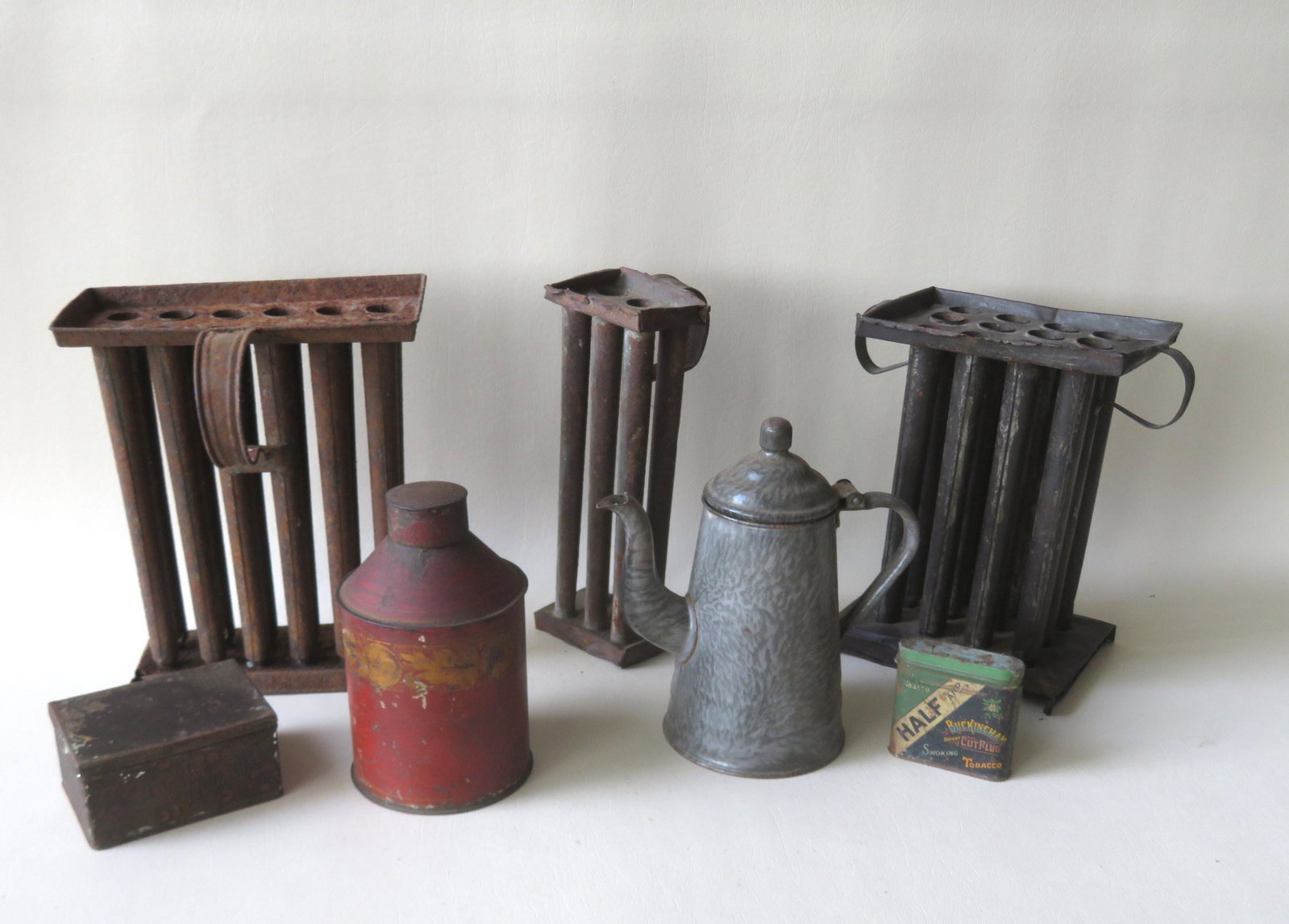 Grouping of country items including: A toleware tea: Grouping of country items including: A toleware tea caddy in original gold and red paint - 7"H; a graniteware coffee pot in very good condition; 2 advertising tins in fair condition; and 3 tin candlem
