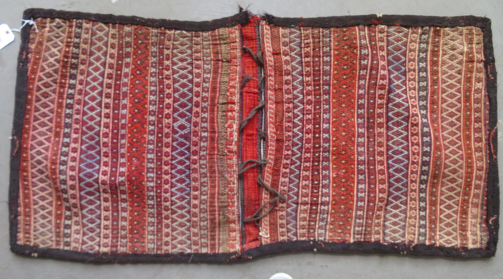 Two oriental tribal saddle bags, middle eastern, early: Two oriental tribal saddle bags, middle eastern, early to mid 20th century - 2' 6" x 4' 8" and 2' 4" x 3' 11". Both in good condition.