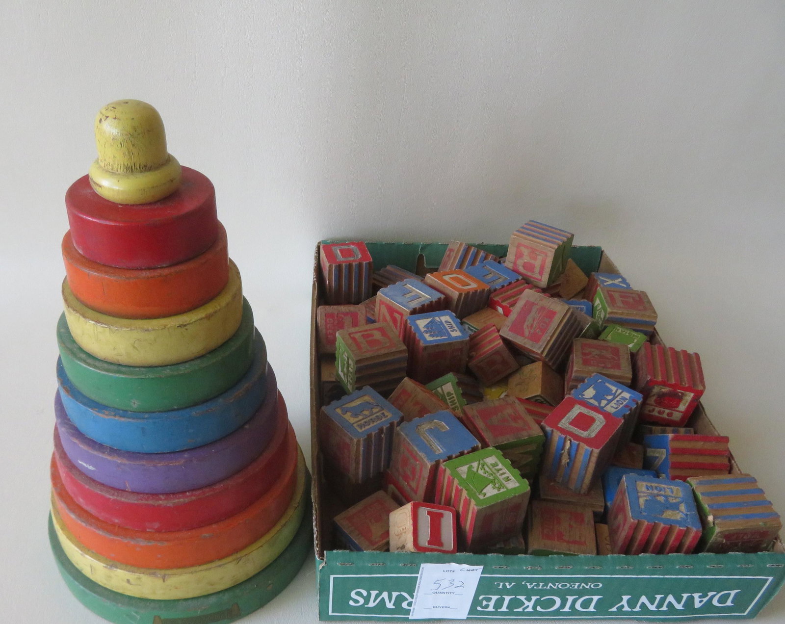 A grouping of toys including vintage child's blocks, a: A grouping of toys including vintage child's blocks, a graduated set of wooden loops that fit over a post in original paint, and an Oracle Ouja board game in original box - good condition.