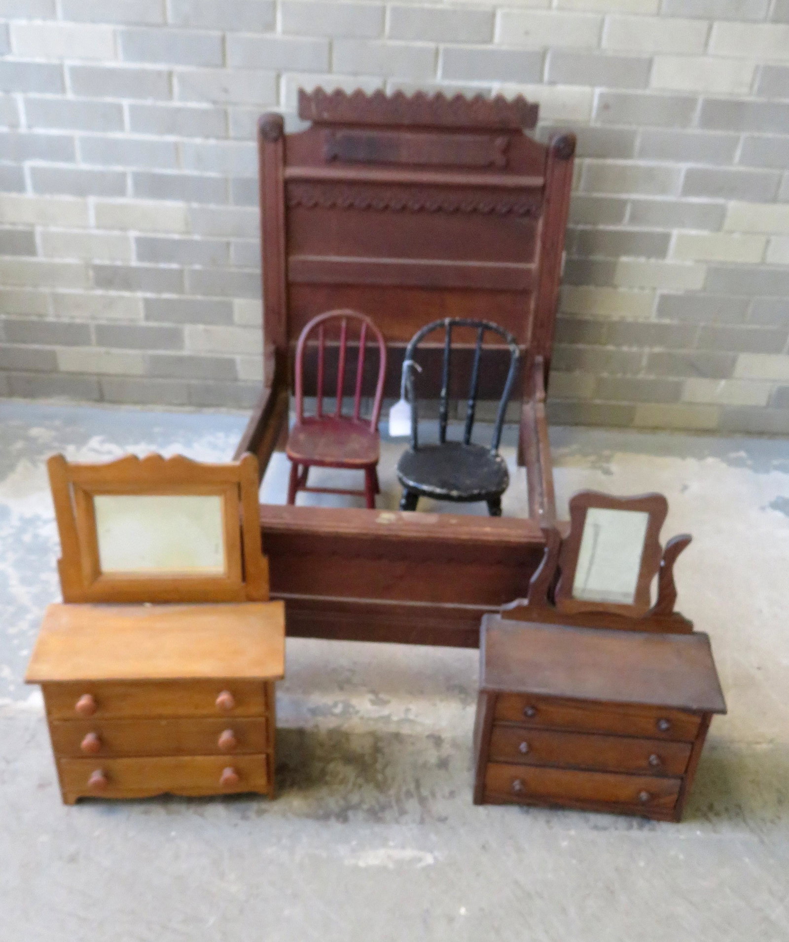 Grouping of doll related wooden collectibles including: Grouping of doll related wooden collectibles including a Victorian Eastlake bed, 2 doll chairs in old paint, and 2 chest of drawers with mirrors. The largest, the bed, measures 35"L x 24 1/2"W x 30 3/