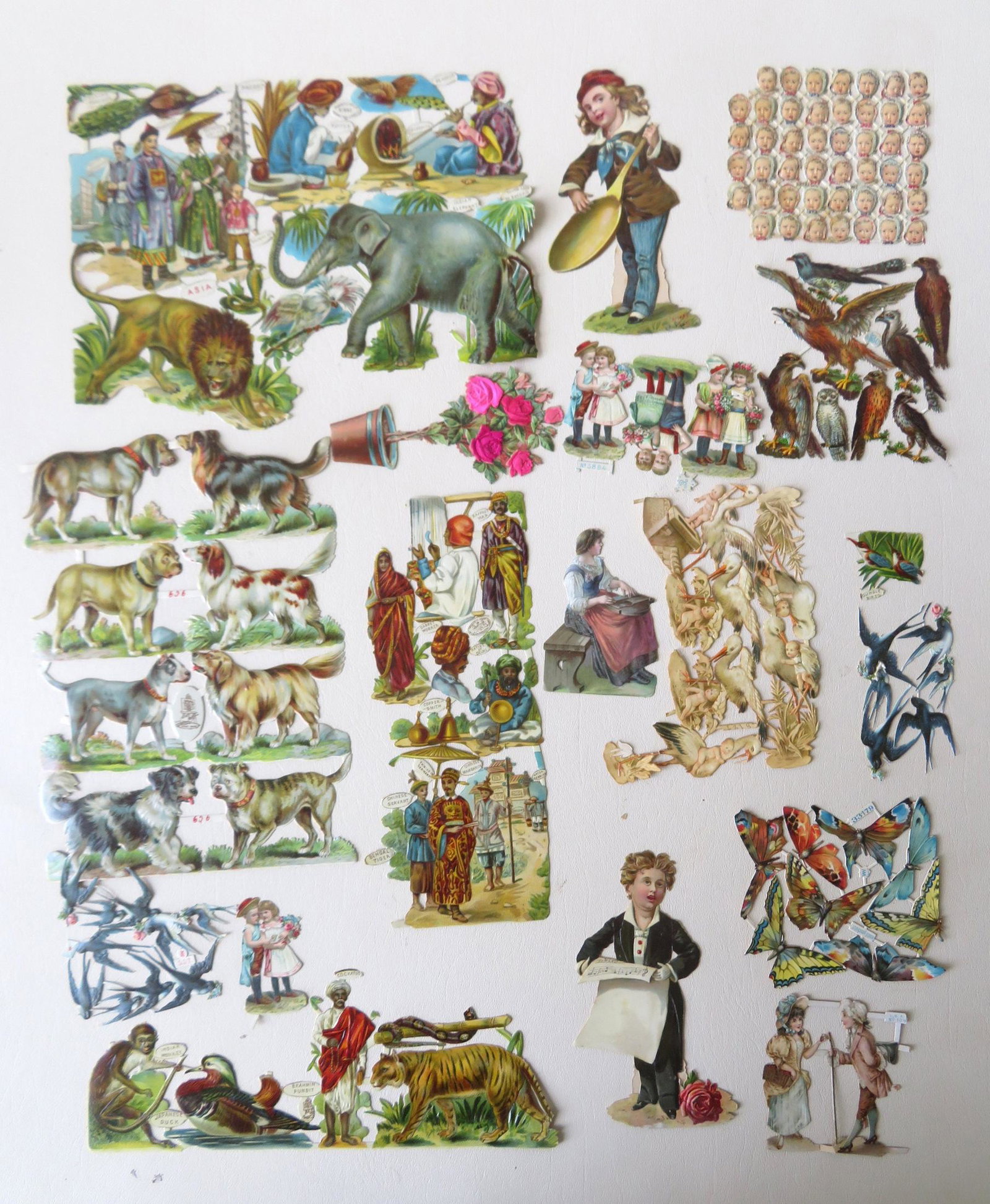 A grouping of 19th century unused paper die-cuts: A grouping of 19th century unused paper die-cuts including occupational, dogs, babies, birds, etc. - one signed "Gigantic Relief / No. 895 / Raphael Tuck & Sons Ltd.". Most in good condition. The shee