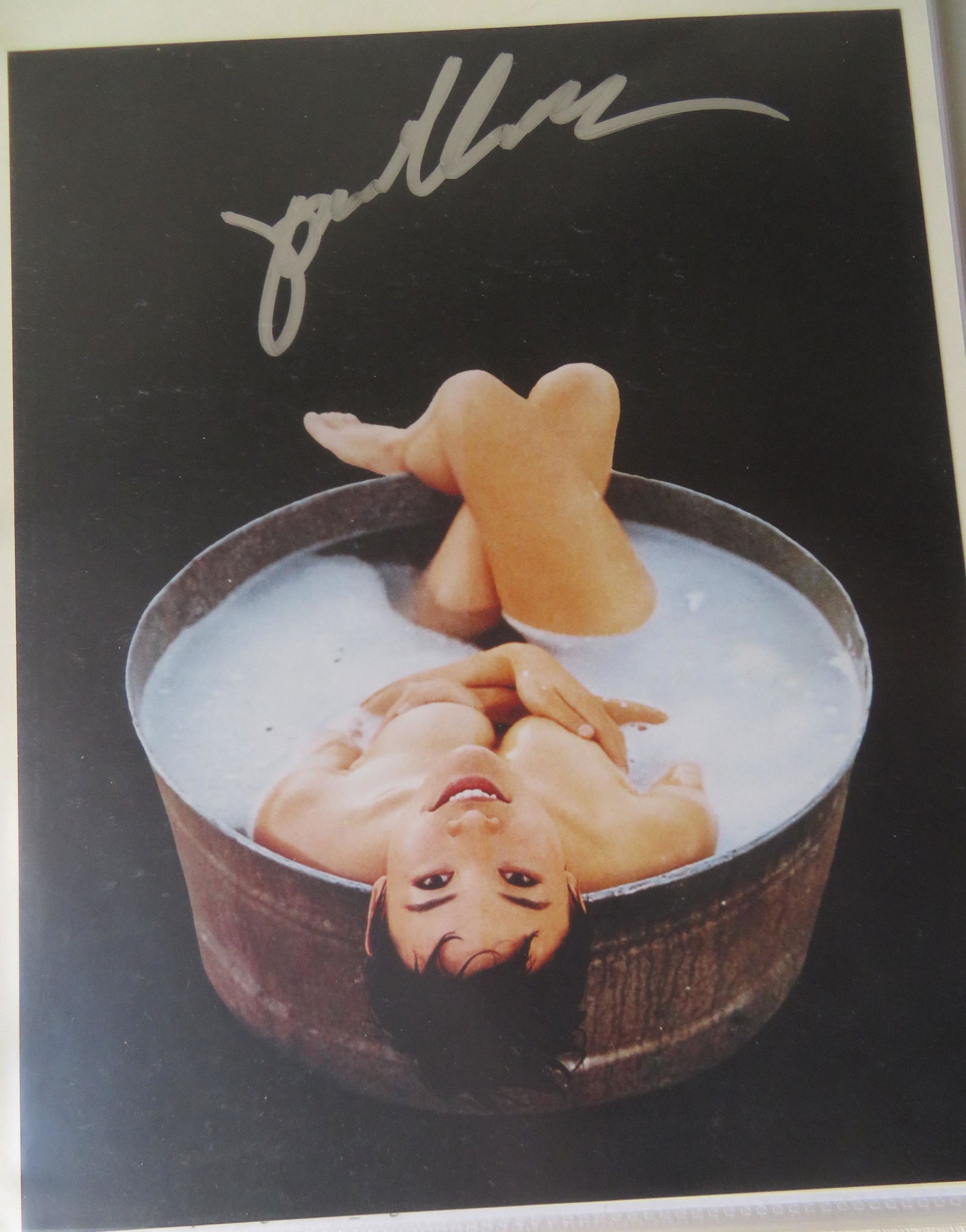 A collection of approximately 60 oriental movie star: A collection of approximately 60 oriental movie star photographic prints in 2 albums including: A Joan Chen autographed photo with Certificate of Authenticity by California Hot Shots; 2 1997 semi-nude