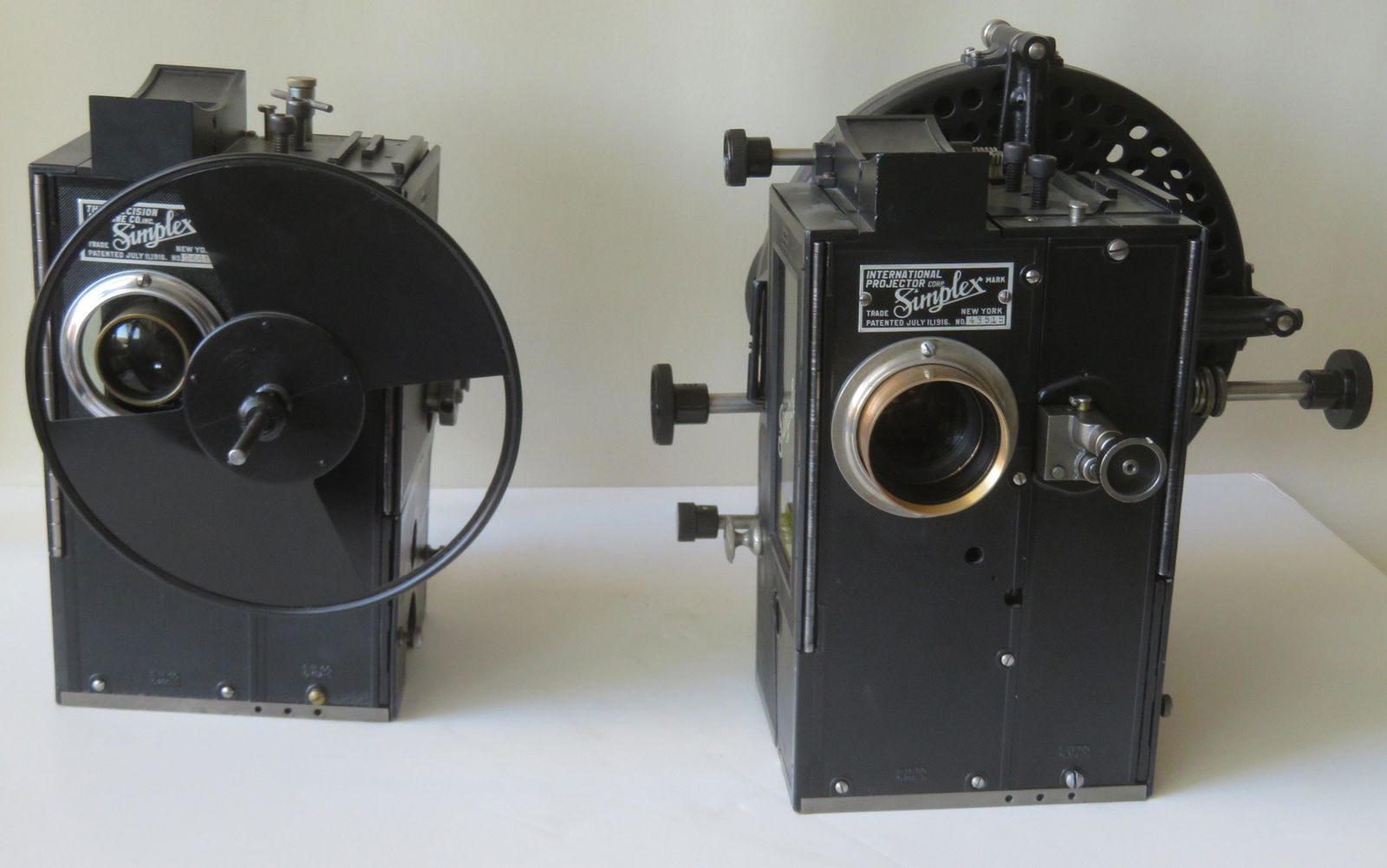 Early pair Of Simplex projector 35 MM heads made by the: Early pair Of Simplex projector 35 MM heads made by the The Precision Machine Co. Inc. New York, patented July 11, 1916. While all items appear in very good condition, none have been tested are are so