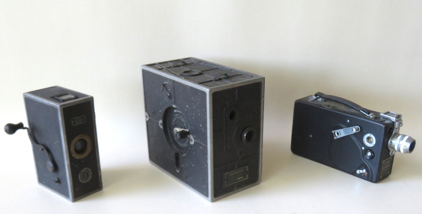 Three early 16mm movie cameras: Three early 16mm movie cameras including: A hand cranked "Baby Standard Movie" camera made by the Vicam Photo Appliance Corporation of Philadelphia; A Cine-Kodak hand crank movie camera - introduced i