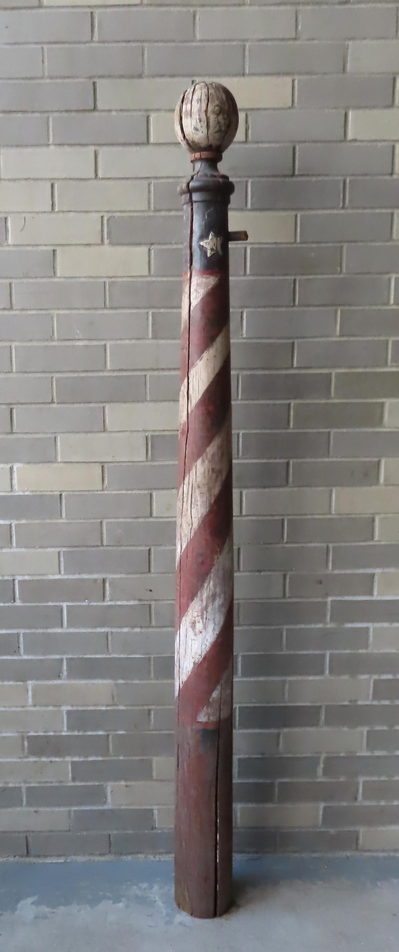 Large turned wooden barber's pole trade sign with: Large turned wooden barber's pole trade sign with carved stars below ball finial, in original red, white and blue paint, untouched but in fair to good condition (paint wear and losses, weathering hair