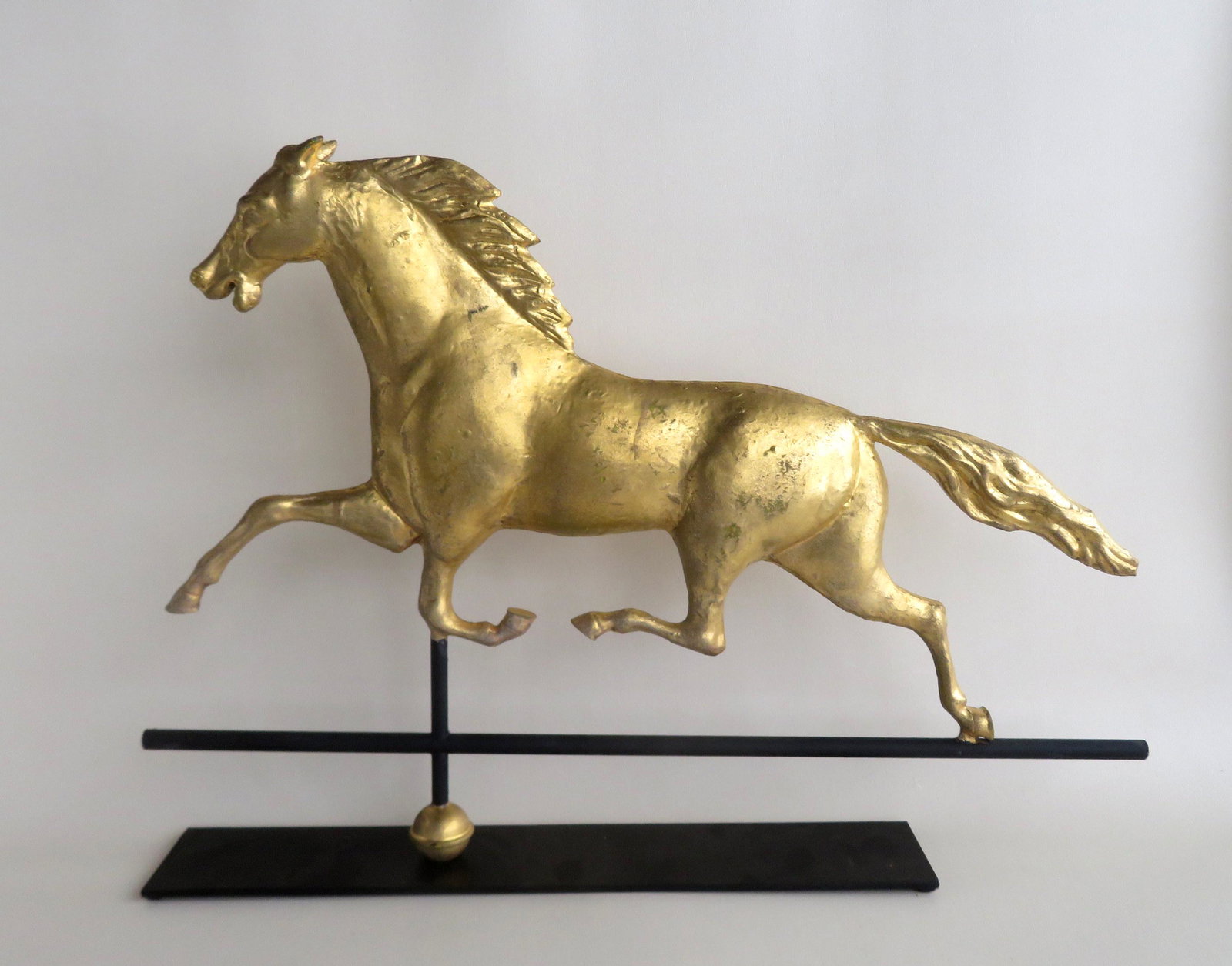 A full body Ethan Allen copper horse weathervane with: A full body Ethan Allen copper horse weathervane with zinc head, newer gilding, circa 1880-1900. Small BB gun impression in body, else very good condition. 31 1/4"L x 21 1/2"H.