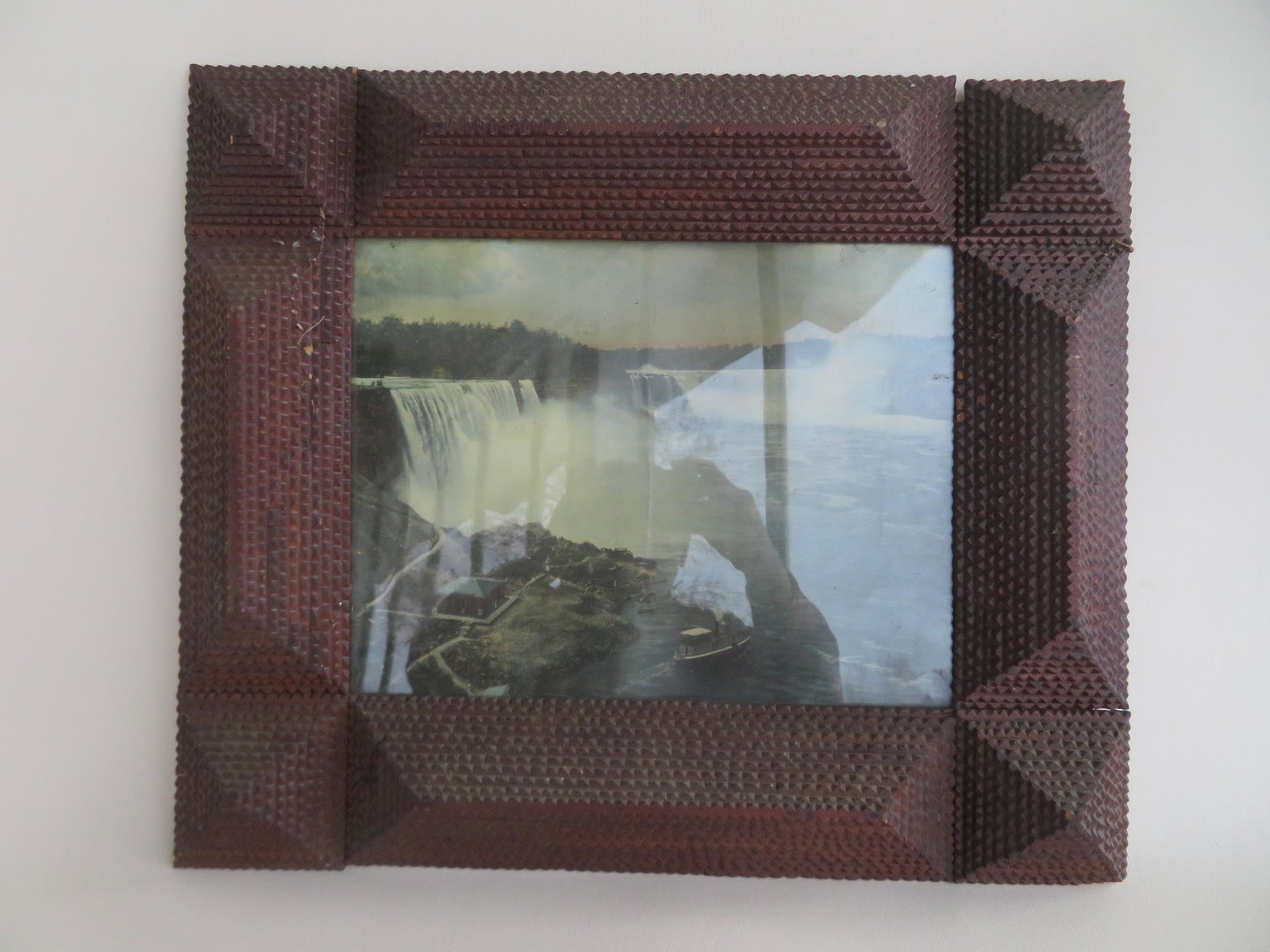 Large tramp art frame currently holding a: Large tramp art frame currently holding a chromolithograph of Niagara Falls, late 19th to early 20th century - total frame size 22" x 19" - opening 15 1/2" x 12 1/4". The frame in very good condition.