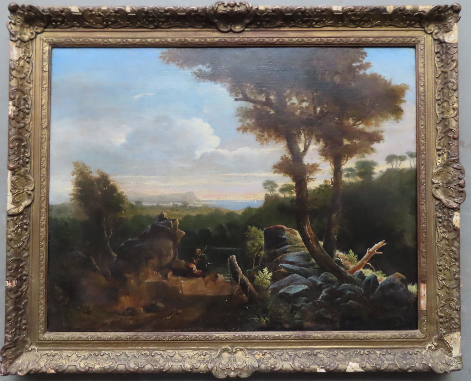 O/C Mountain landscape depicting man with walking stick: O/C Mountain landscape depicting man with walking stick and woman seated on rocks overlooking valley below with town near edge of water, signed W. Williams 1839 (William Williams, English, 1808-1895).