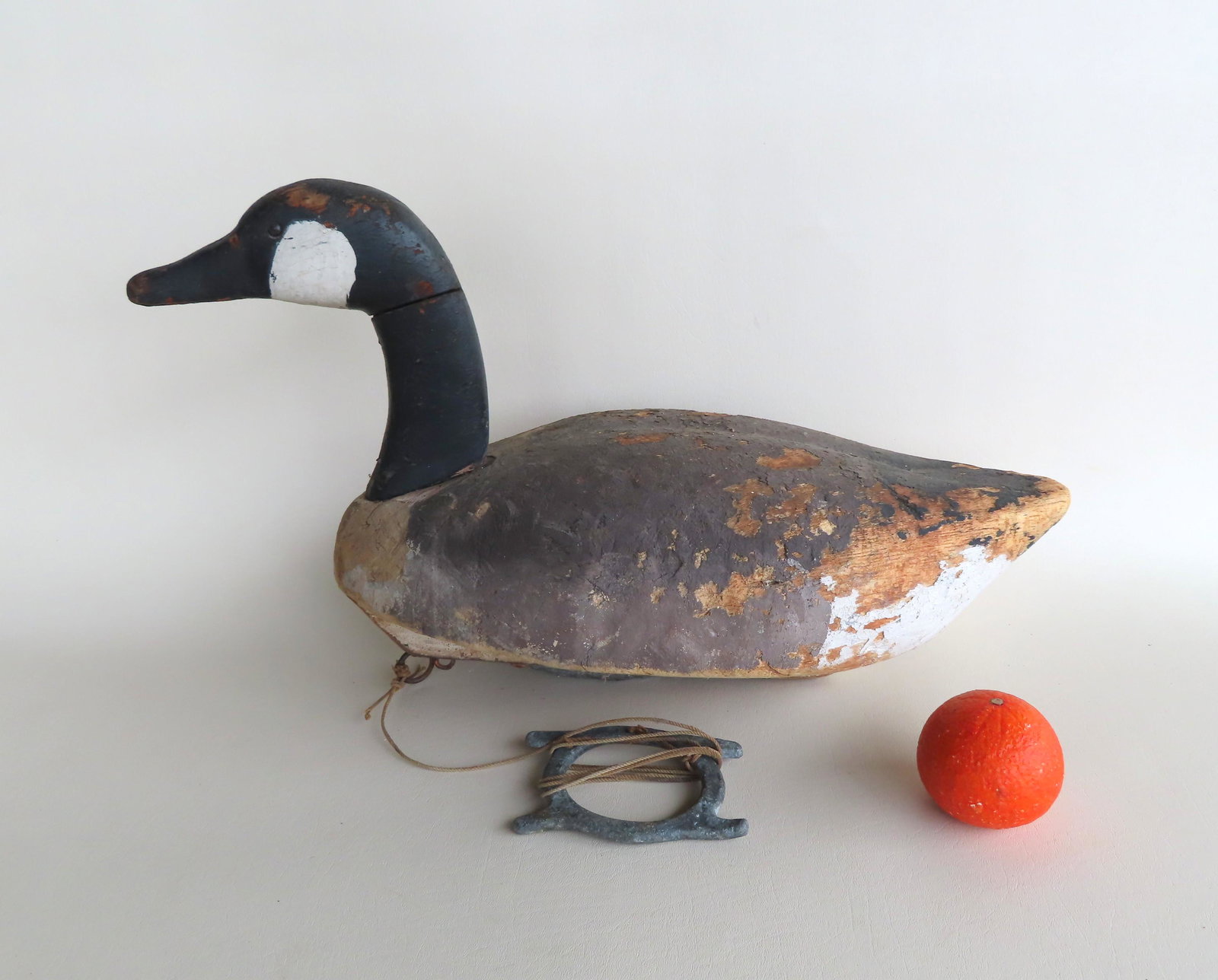 Primitive Canadian goose decoy in original paint - use: Primitive Canadian goose decoy in original paint - use wear to paint, repair to neck, overall good condition. Size 22 1/2"L x 12 1/2"H.
