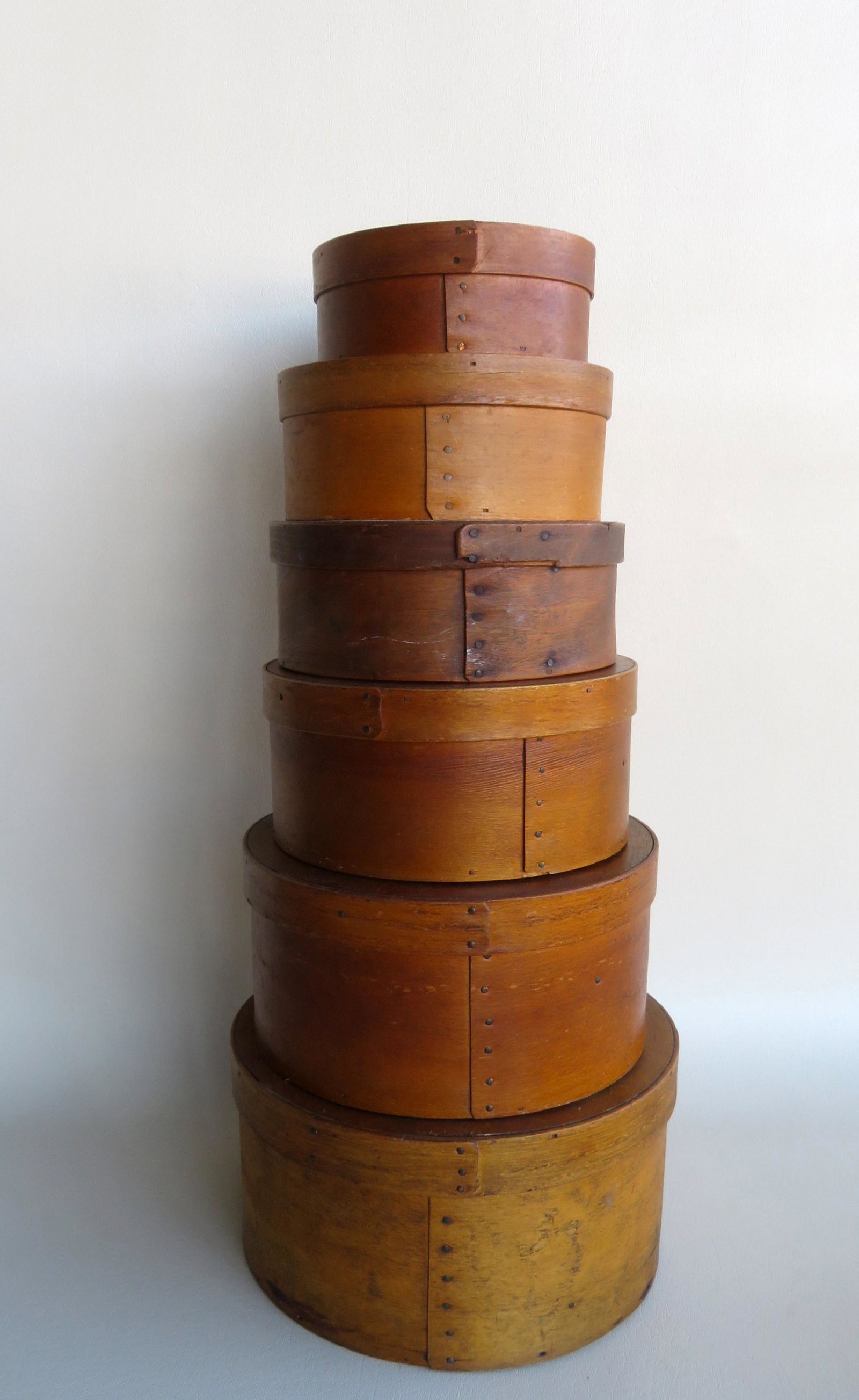 A nested stack of 6 pantry boxes, ranging in size from: A nested stack of 6 pantry boxes, ranging in size from 5 1/2"diameter x 2 1/2"H to 9 1/2"diameter x 5"H. All in very good condition. Mid to late 19th century.