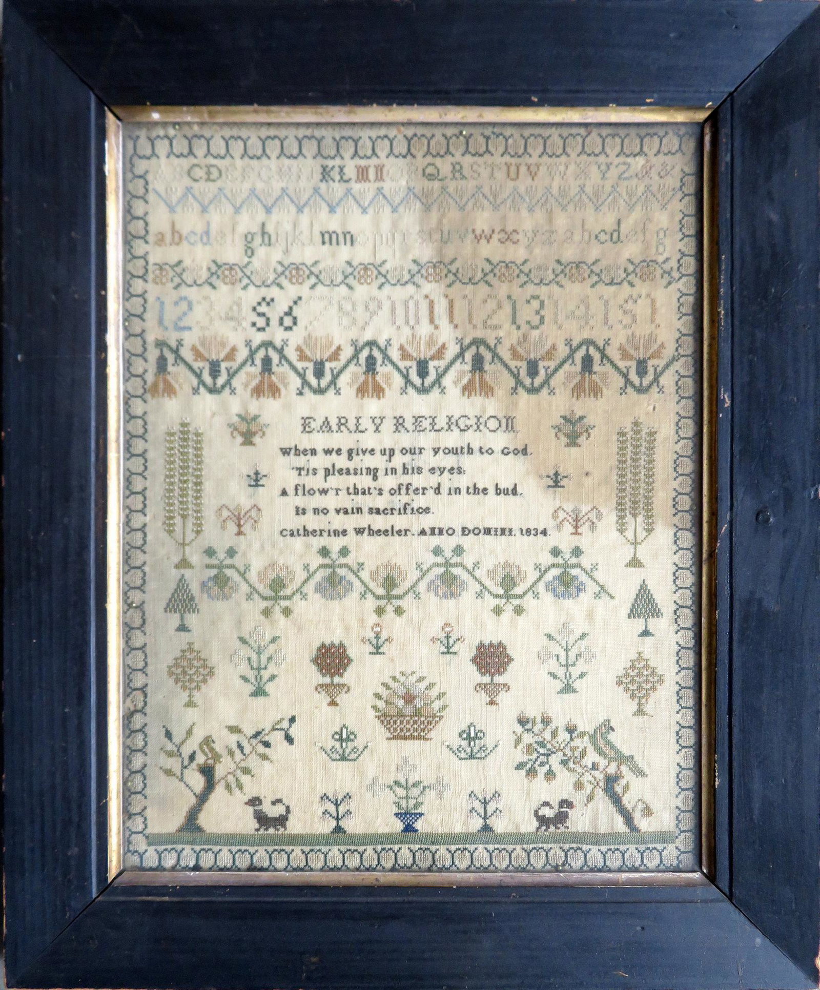 Sampler, alphabet and pictorial, signed "Catherine: Sampler, alphabet and pictorial, signed "Catherine Wheeler / Anno Domini 1834" beneath religious poem. The sampler decorated with alphabet and numbers on the top half of the sampler and the bottom hal