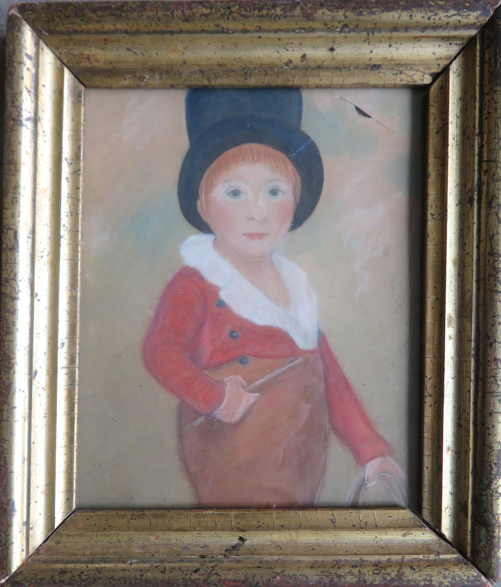 A primitive pastel portrait of a young boy wearing a: A primitive pastel portrait of a young boy wearing a top hat and holding a riding crop, 1830-40 - tear In upper right corner, else good condition. Mounted in a period lemon gold frame. Total frame siz