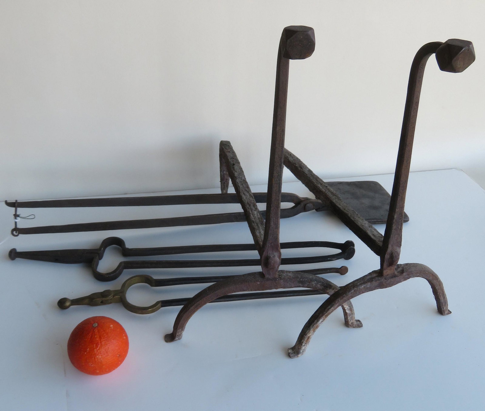 Grouping of early hearth items including: Pair of hand: Grouping of early hearth items including: Pair of hand forged goose neck andirons with diamond shaped terminals - 16 1/2"H; waffle iron with floral pattern - 27 3/4"L; and 2 iron fireplace tongs -the 