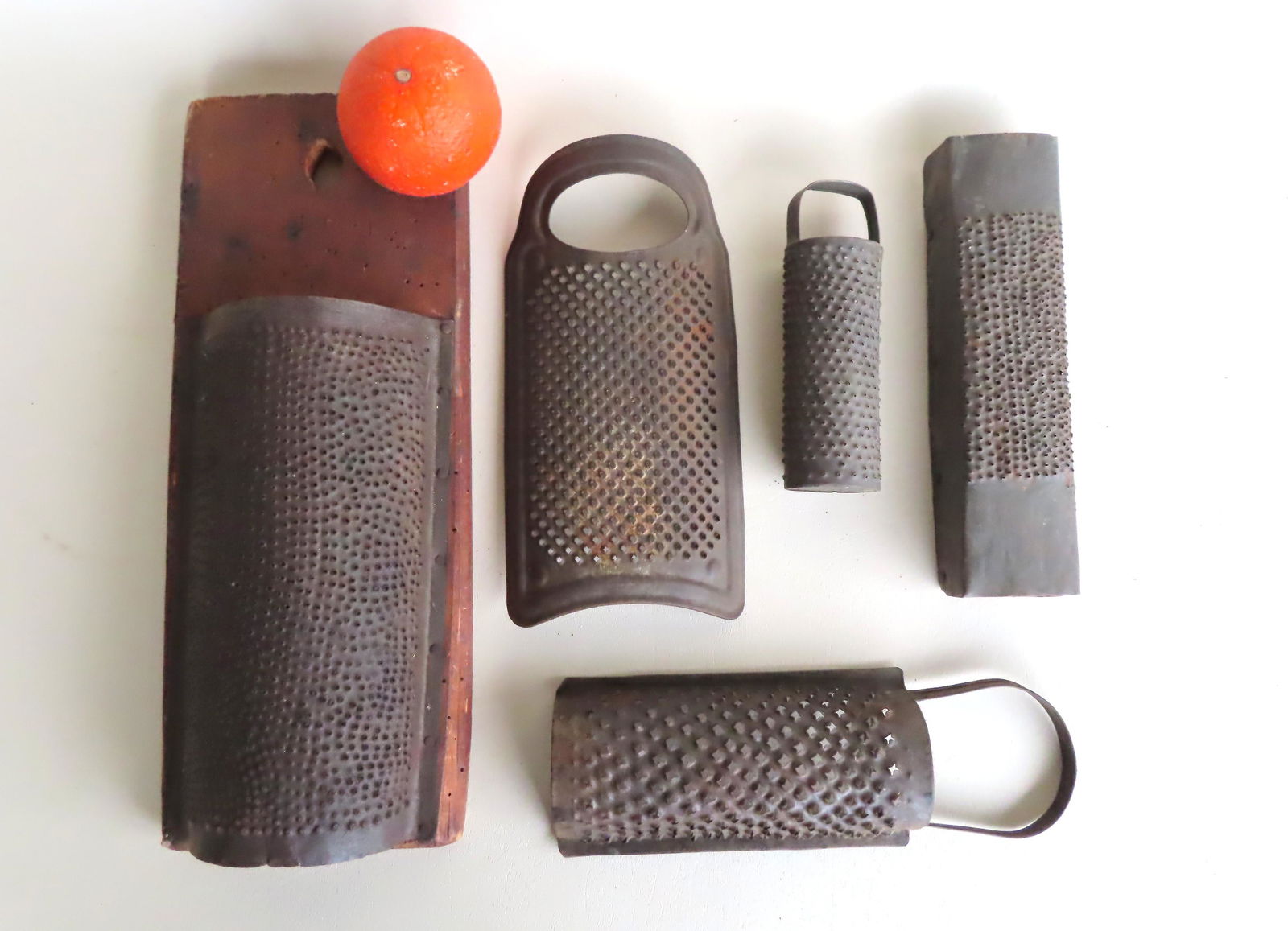 Grouping of 5 early tin graters ranging in size from: Grouping of 5 early tin graters ranging in size from 6"H to 15"H x 6"W. All in good condition. Provenance: From a Long Island NY country estate, name withheld by family.