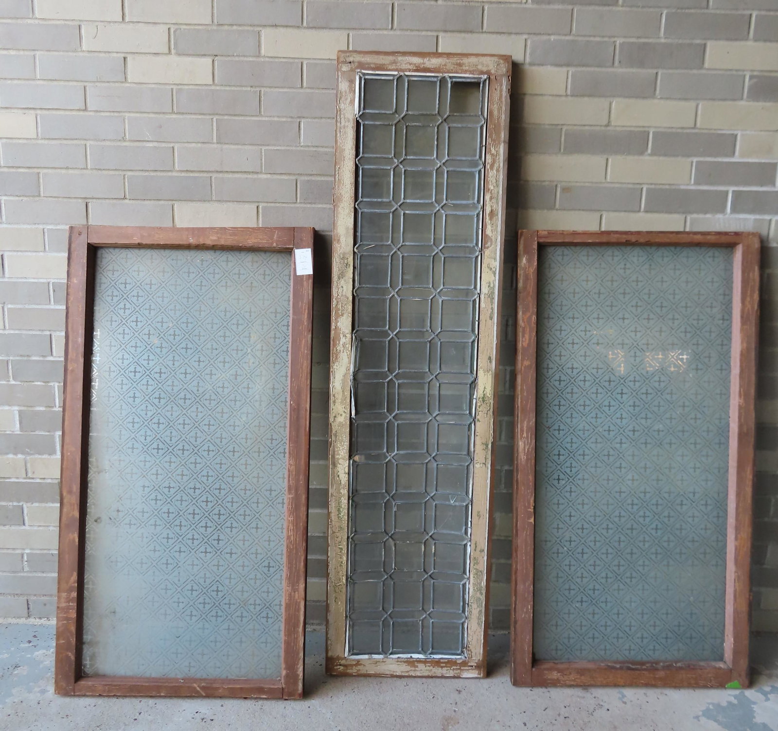 Three decorative windows, late 19th to early 20th: Three decorative windows, late 19th to early 20th century, including 2 matching frosted windows decorated in a geometric pattern - each 23 1/4" W x 44 1/4"H - good condition; and 1 leaded glass window