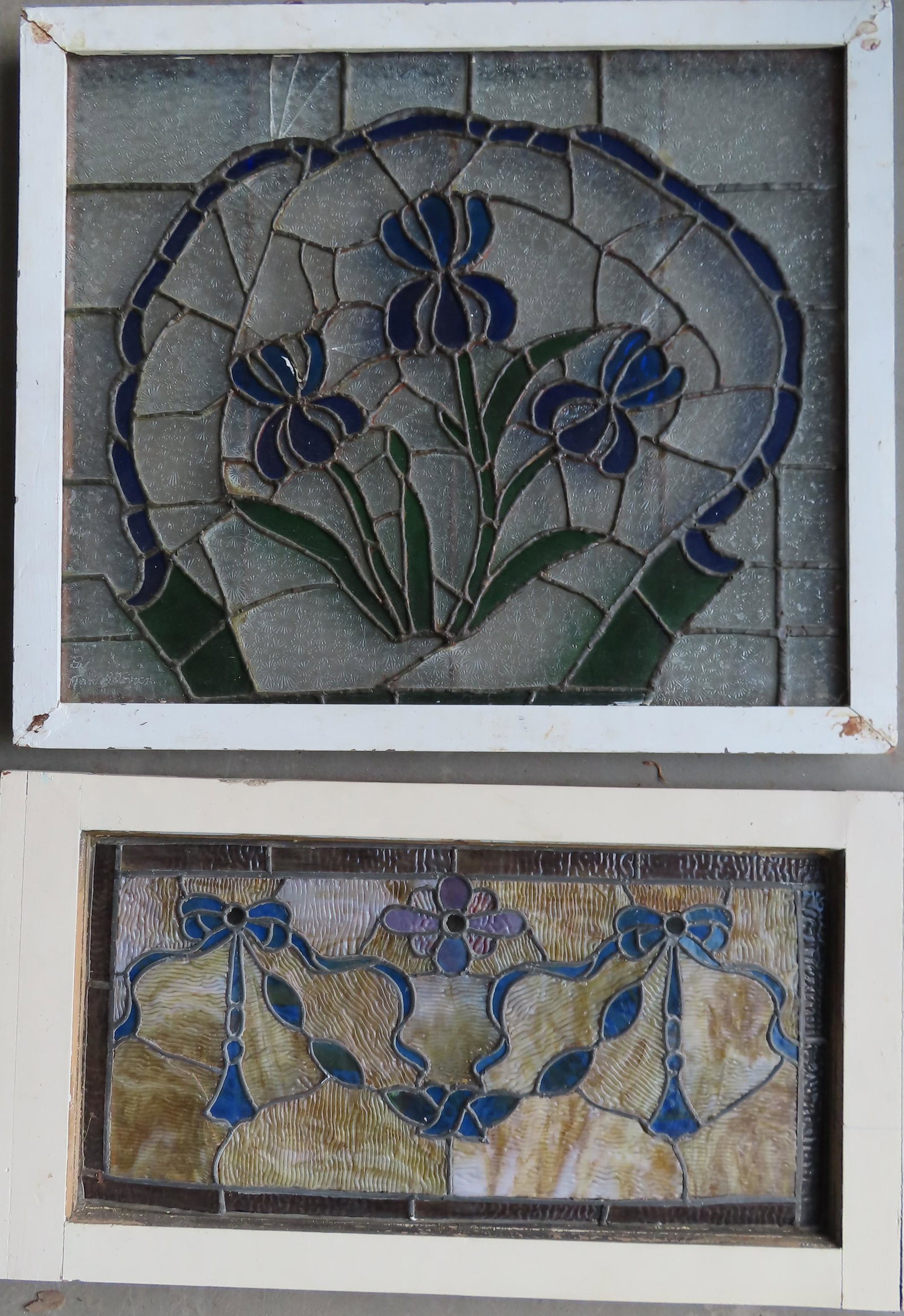 Two leaded and stained glass windows with floral: Two leaded and stained glass windows with floral decorations, circa 1910-20. Each with hairline cracks in glass, but overall good condition. 29 3/4" x 16" and 28 1/2" x 24".