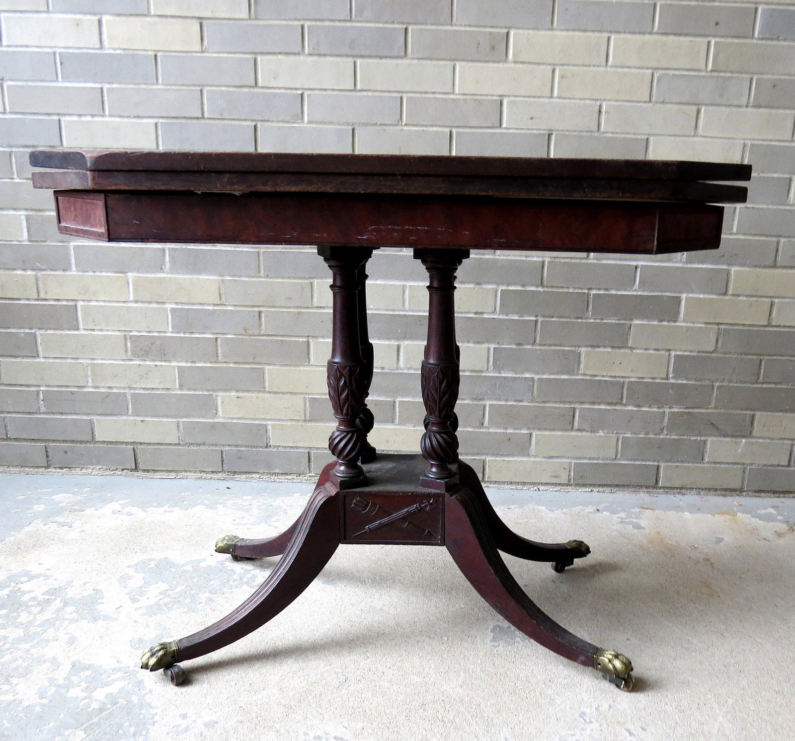 A Federal mahogany card table attributed to Duncan: A Federal mahogany card table attributed to Duncan Phyfe NY, circa 1810-1815, with shaped top over 4 turned columns with acanthus leaf carved urns terminating on spiral carved balls attached to suppor