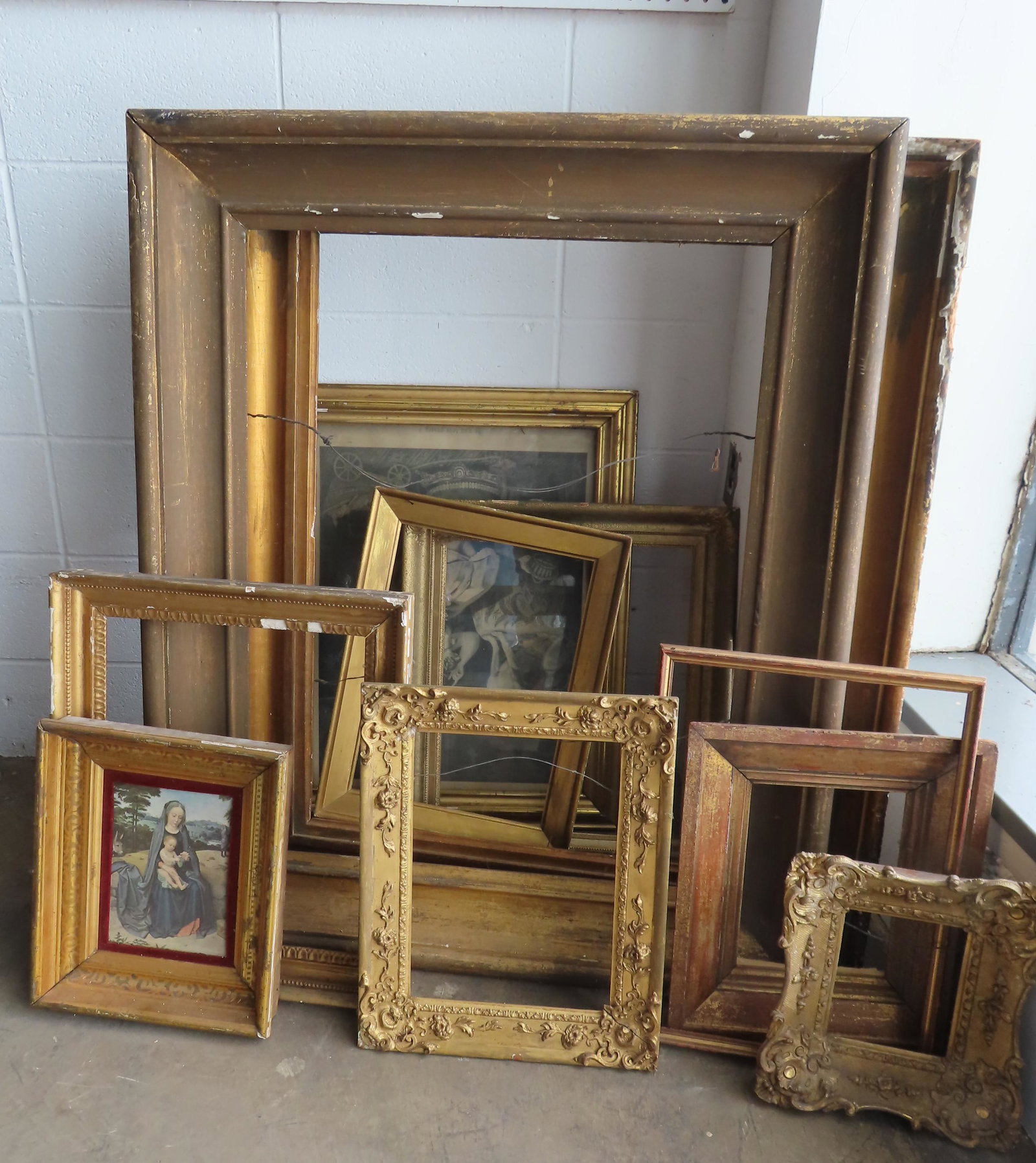 Grouping of 11 early frames including 2 large lemon: Grouping of 11 early frames including 2 large lemon gold portrait frames in need of restoration, early to mid 19th century; several lemon gold frames with some gesso losses, and other gilt gesso frame
