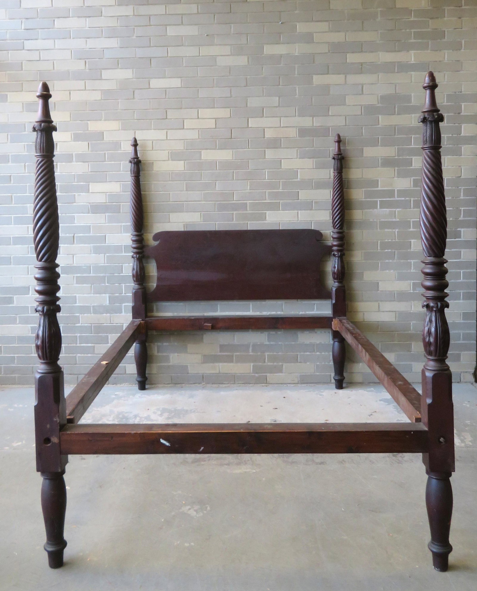 A Sheraton mahogany tall poster bed with spiral: A Sheraton mahogany tall poster bed with spiral turnings and acanthus carvings under acorn finials, circa 1820. Measures 65 1/2"H x 76 1/2"L (side rails) x 54 5/"W (to outside of side rails). Original