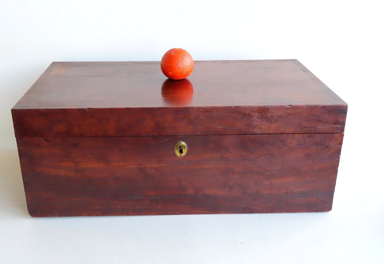A very high quality figured mahogany storage box with: A very high quality figured mahogany storage box with brass handles and original lock (missing key). Overall very good condition, late 18th century. Measures 25 3/4"W x 14 3/8"D x 10"H. Provenance: Fr