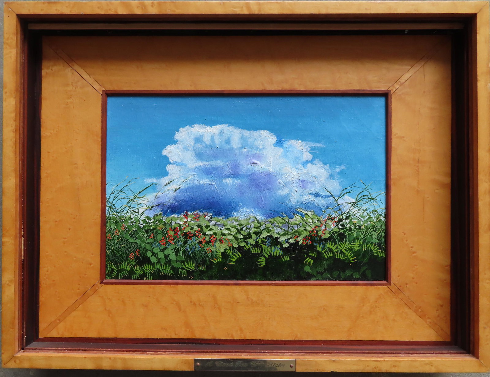 An unusual painting in a deep birdseye maple custom: An unusual painting in a deep birdseye maple custom made frame, with a semi transparent linen shield place on the inside of glass to obscure the landscape painting with billowing clouds and colorful f