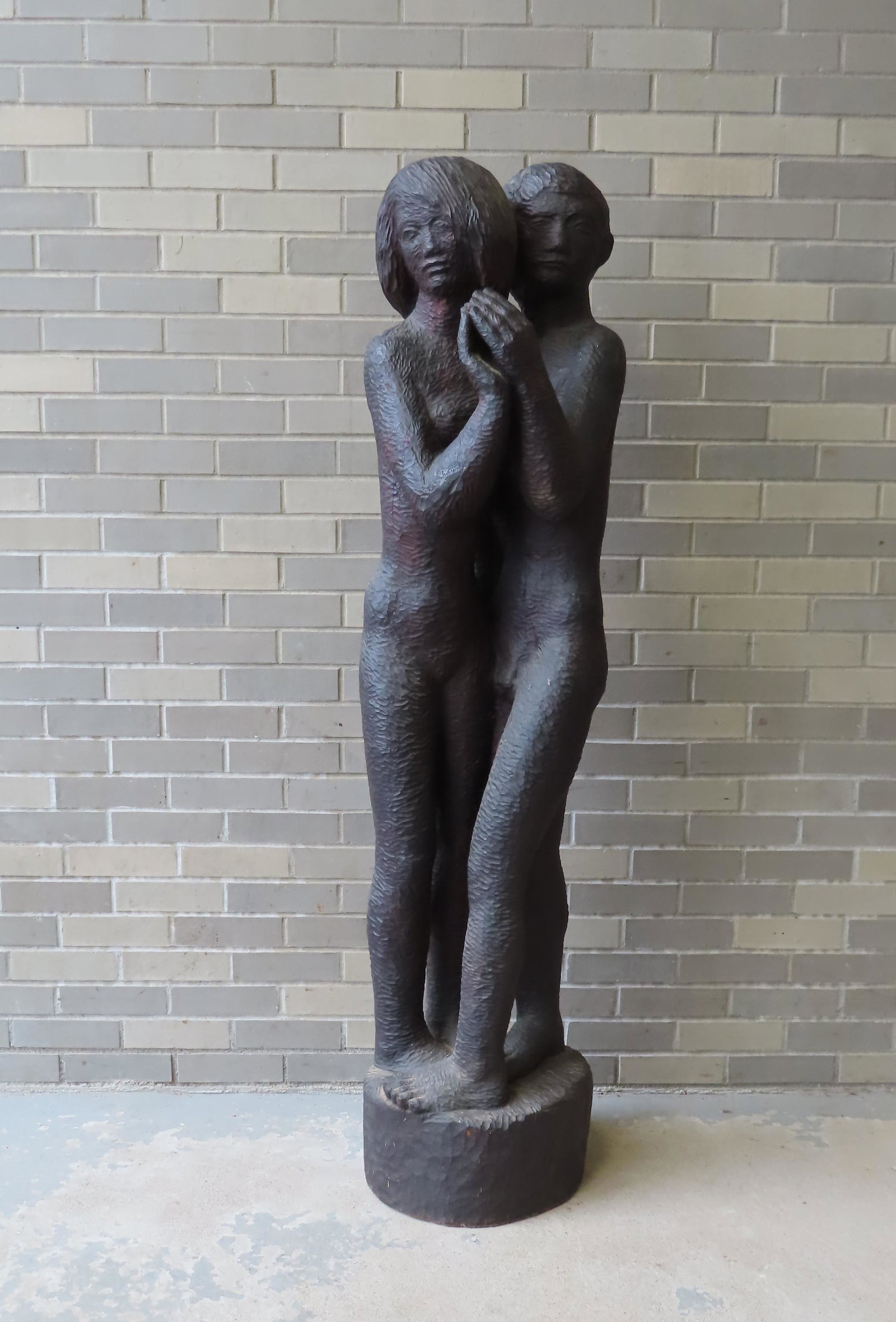 A large modernistic wood carving of a nude man and: A large modernistic wood carving of a nude man and woman embracing each other, symbolic of Adam & Eve - mid 20th century. Not signed. Very good condition. Measures 64"H x 14" diameter at base.