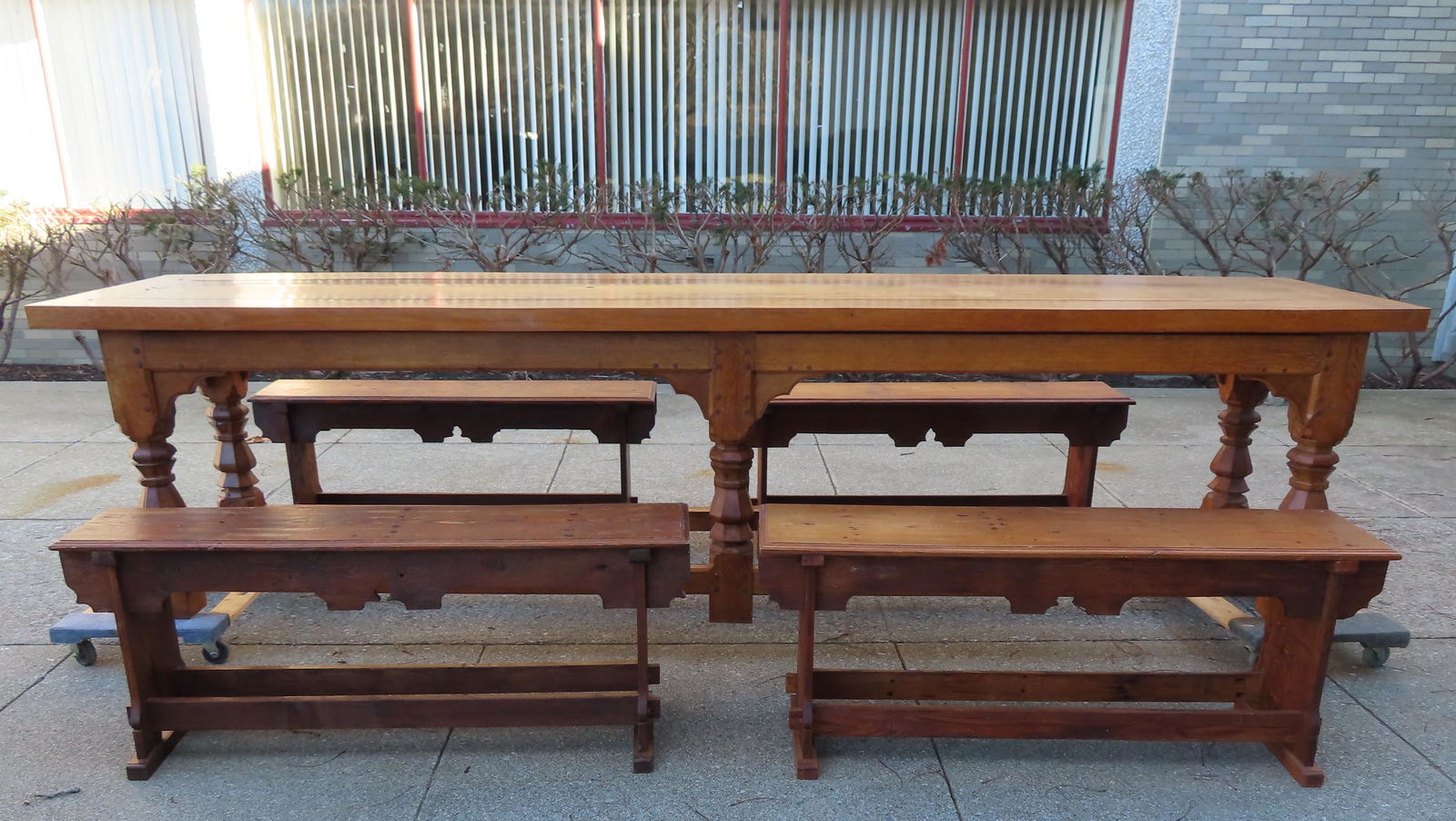 A large Arts and Crafts custom made oak dining table: A large custom made medieval style oak dining table with 4 matching benches. This is a one of kind exact replica of a Renaissance Table in the Victoria Albert Museum, London, England. It was bench mad