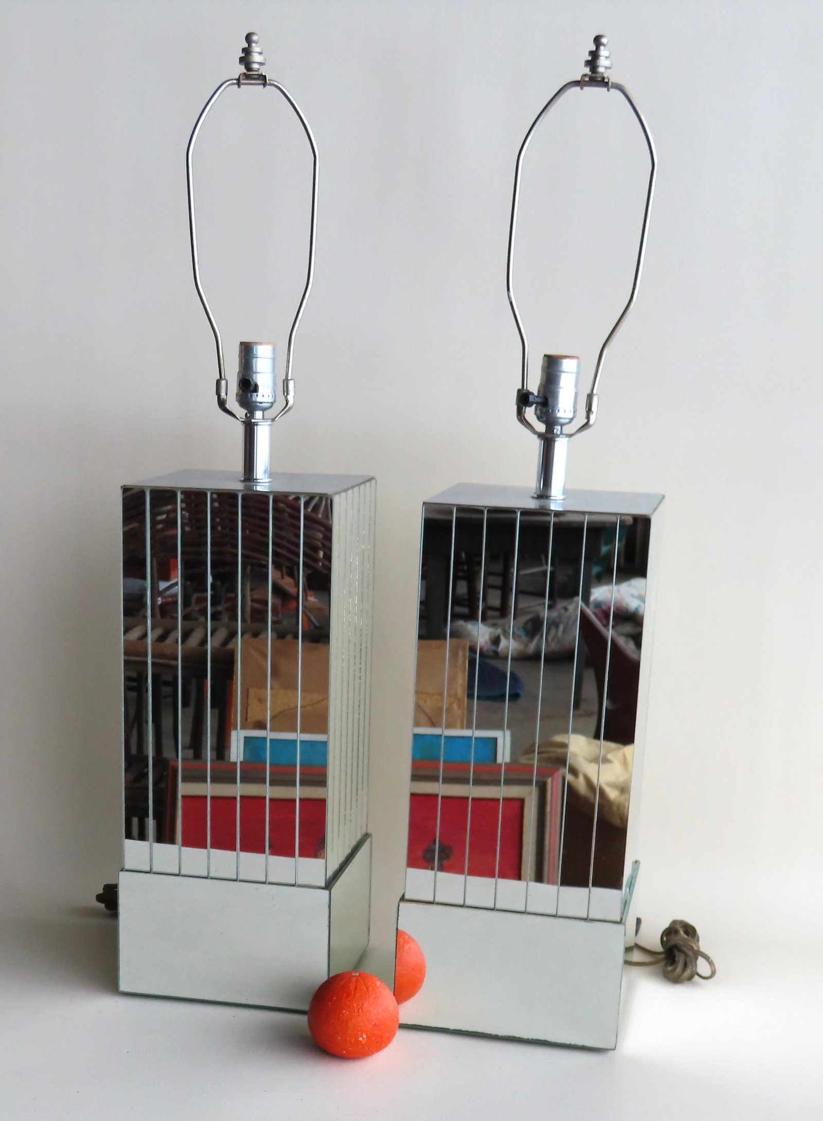 Pair of mid century modern table lamps with mirror: Pair of mid century modern table lamps with mirror paneled sides, mid 20th century, good condition. Each measures 32 1/2"H (to top of lamp shade finial) x 7 1/2" square.