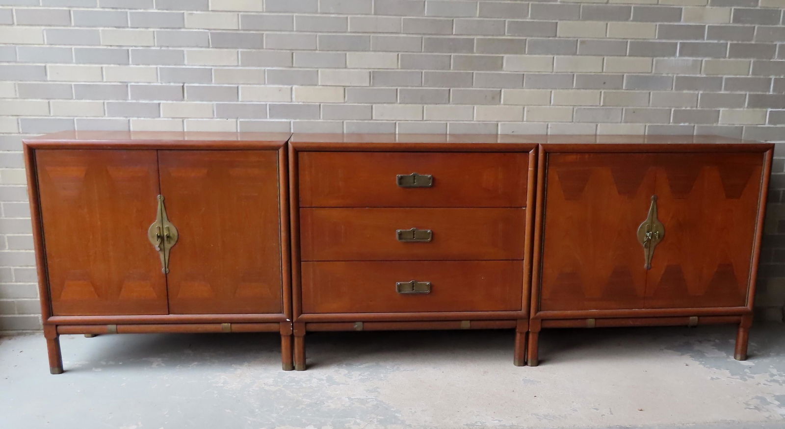 A matching 3 piece mid century style furniture set in: A matching 3 piece mid century style furniture set in cherry with mahogany inlays, and small chamfered legs, probably for a living room but was used in a dining room setting. Consisting of 2 identical