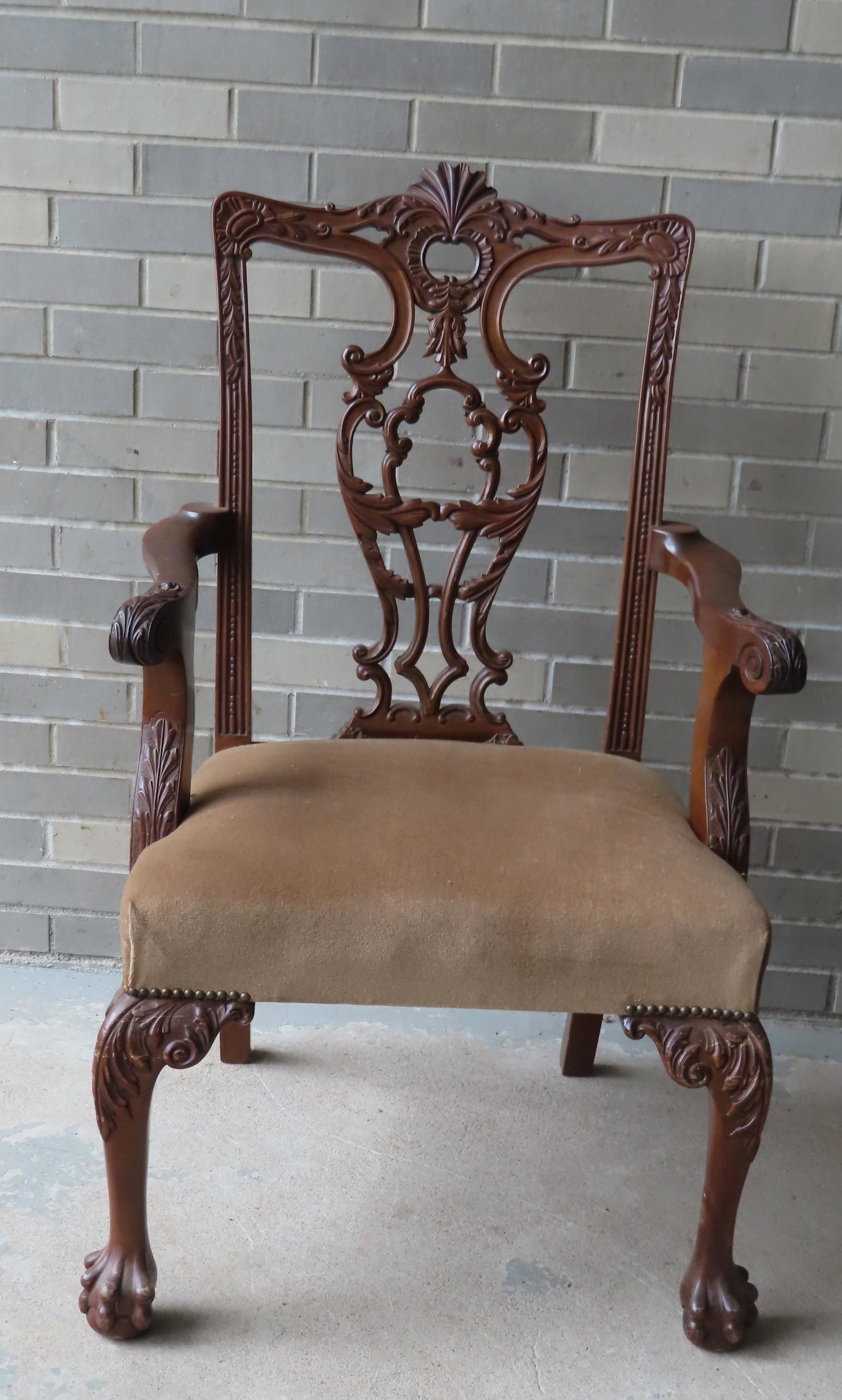An ornate Chippendale style custom made chair with: An ornate Chippendale style custom made chair with heavily carved crest and back splat, scrolled arms with acanthus carvings, and acanthus carved knees on legs with carved claw feet. Probably Centenni