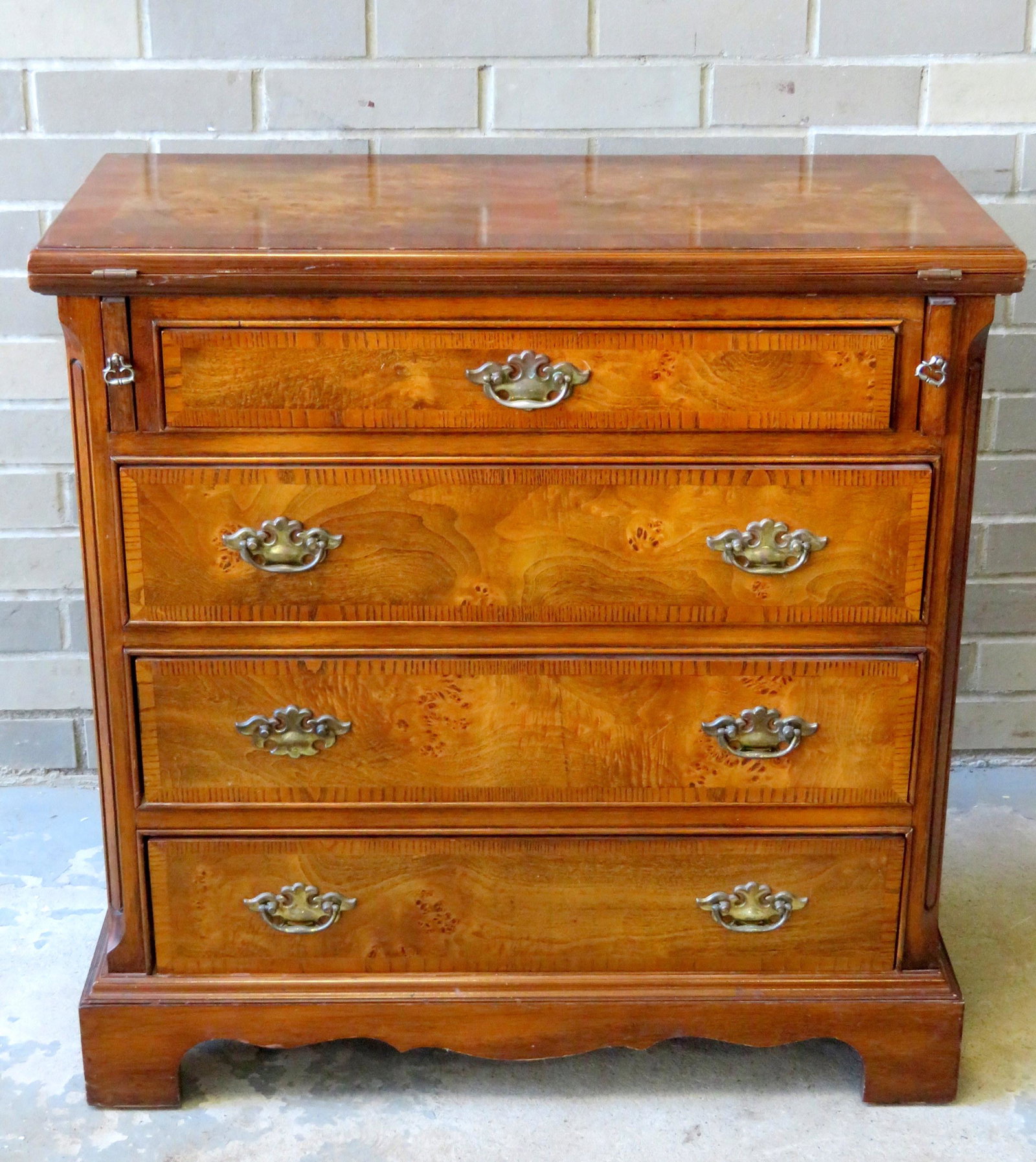 A modern Chippendale style 4 drawer burled walnut chest: A modern Chippendale style 4 drawer burled walnut chest with a flip-top writing surface, circa 2000. Very good condition. 28 1/4"W x 14"D x 28 3/4"H.