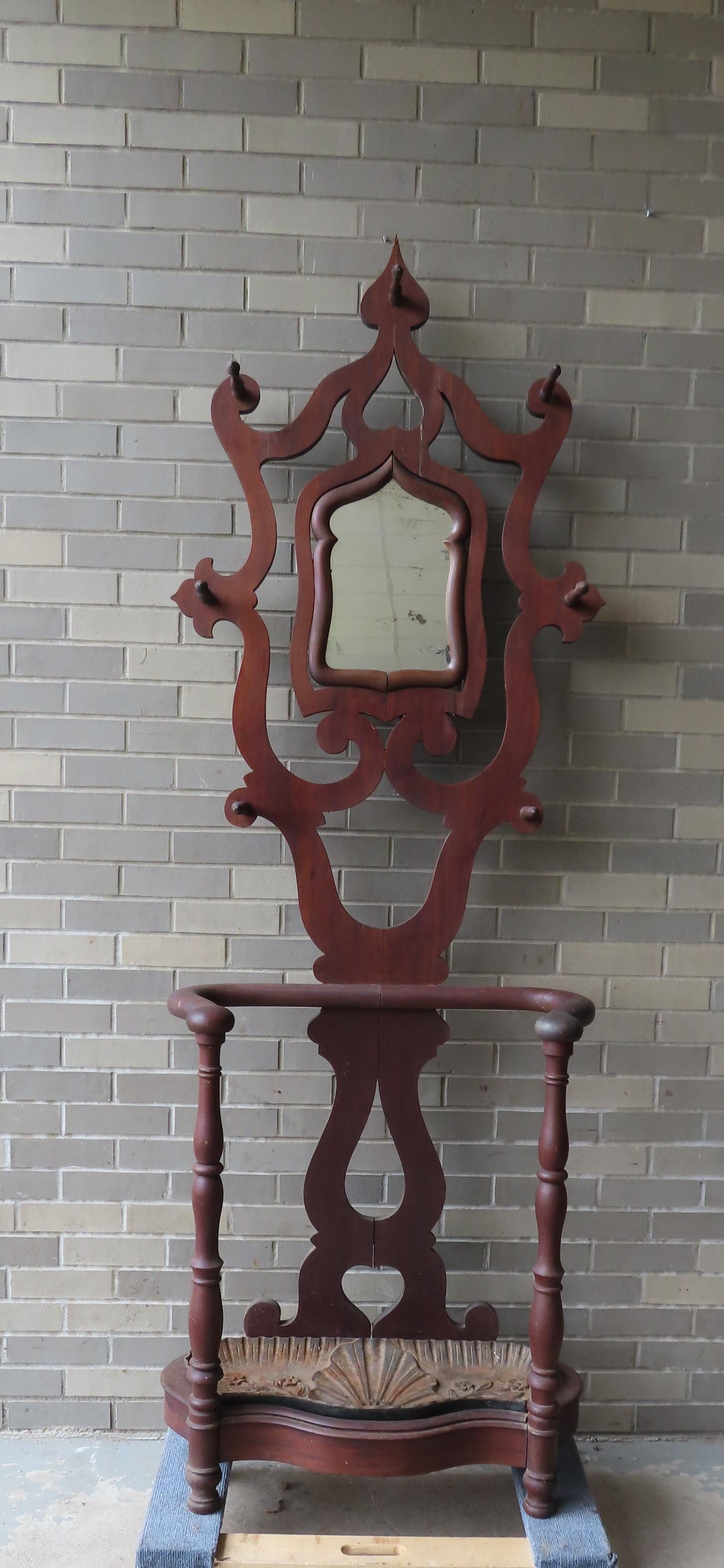 Gothic Empire mahogany hall stand with mirror back, hat: Gothic Empire mahogany hall stand with mirror back, hat hooks, and curved arms for holding umbrellas and walking sticks - base with embossed floral decorated cast iron insert. Small repair to frame ho